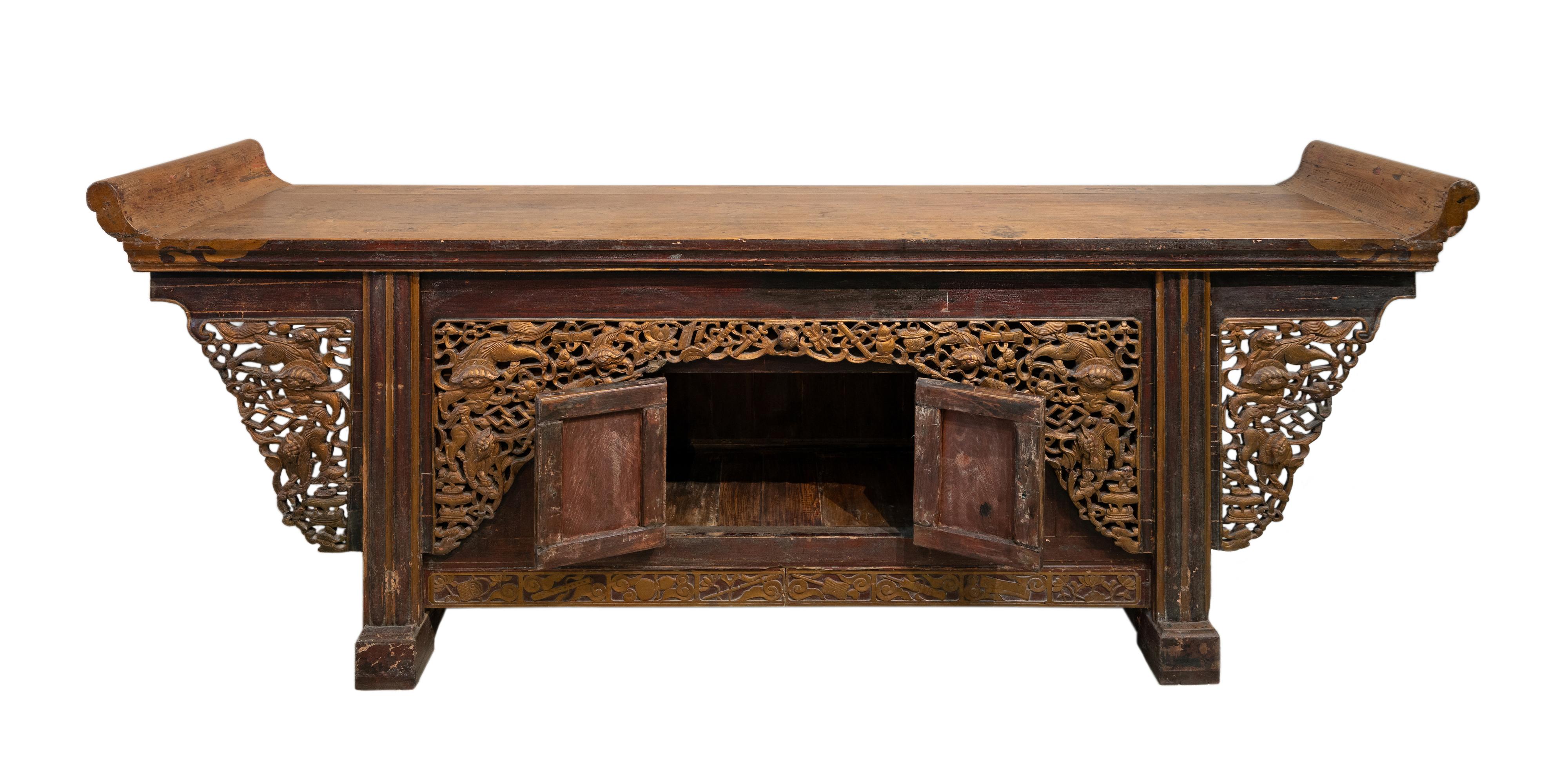 A very impressive large sideboard with everted ends from Shanxi province, China. The through carvings across the front has very lively and protruding carvings of lions (12 in total) and the 