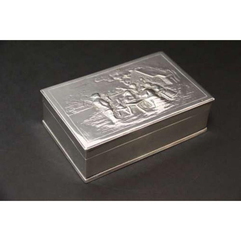 An Early 19th century silver box

This good quality early 19th century Netherlands hallmarked box is very well made and of a good weight. It has a decorative lid with an embossed scene depicting a group of villagers gathered outside an inn