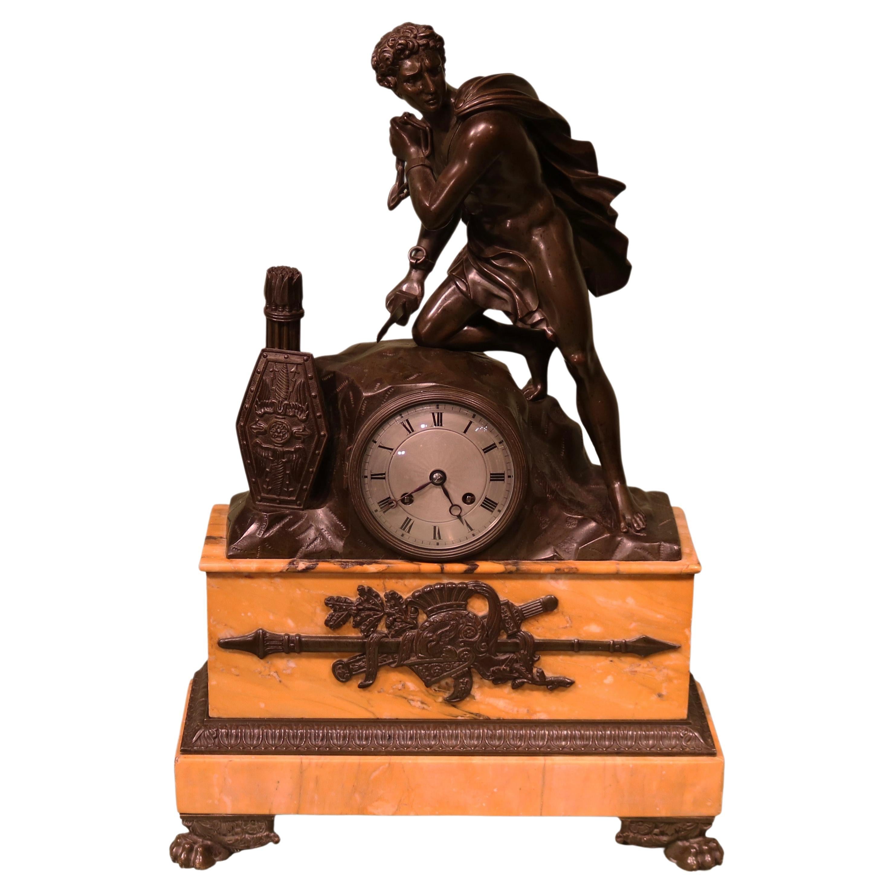 An early 19th century French bronze and marble mantel clock For Sale