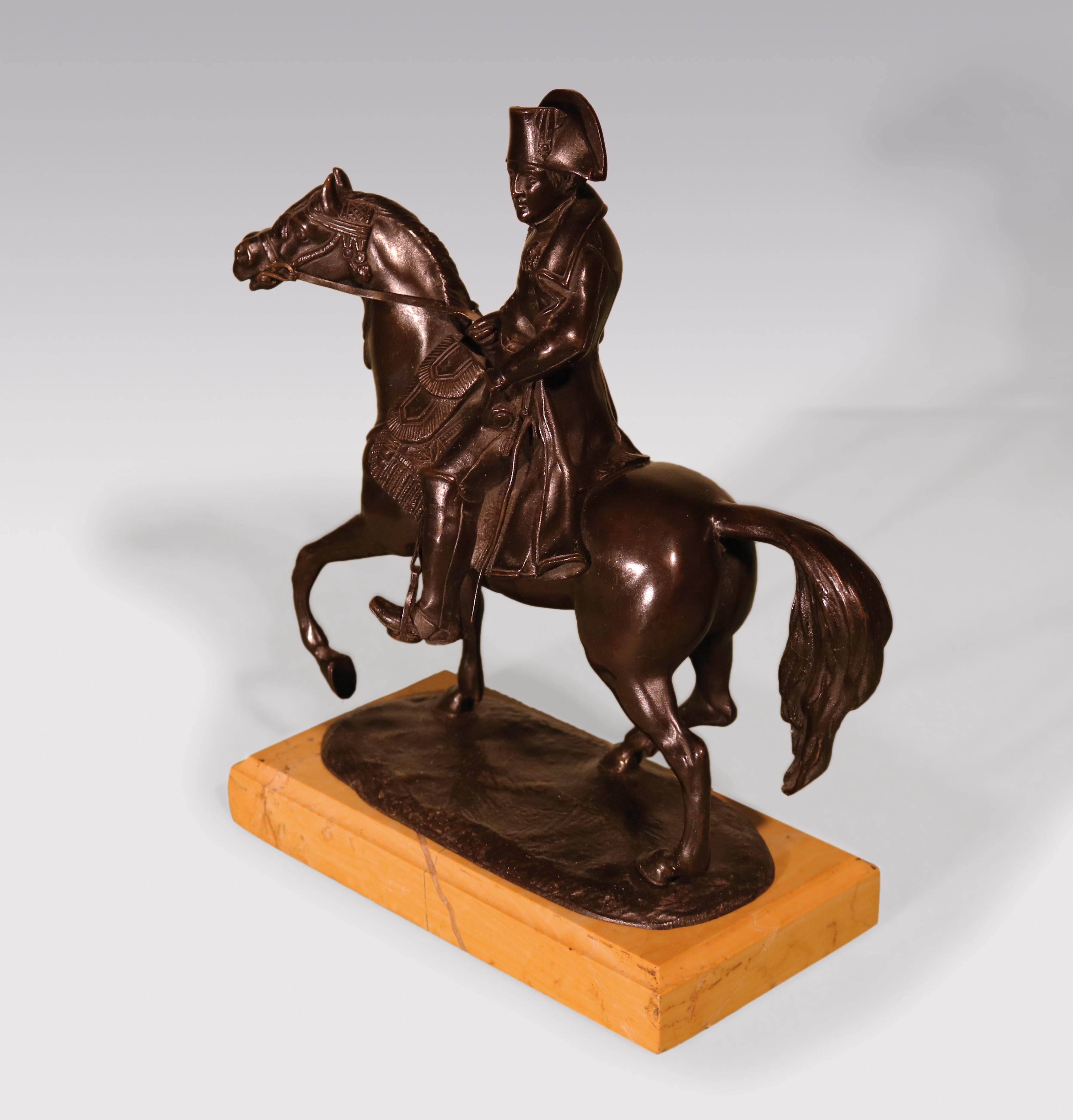 An early 19th century well-cast detailed bronze of Napoleon riding his famous horse Marengo supported on moulded Sienna marble base.