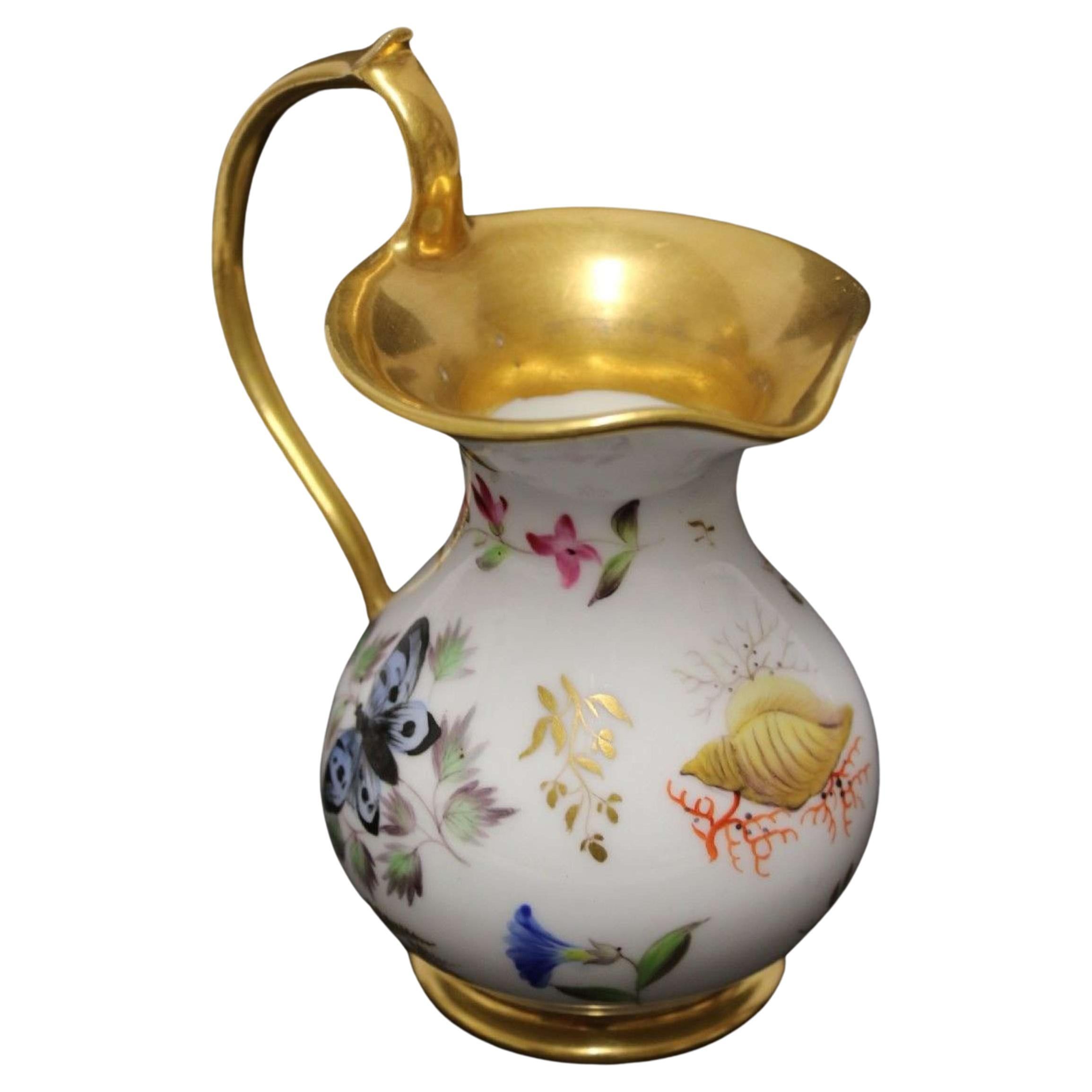 An early 19th century French porcelain miniature ewer