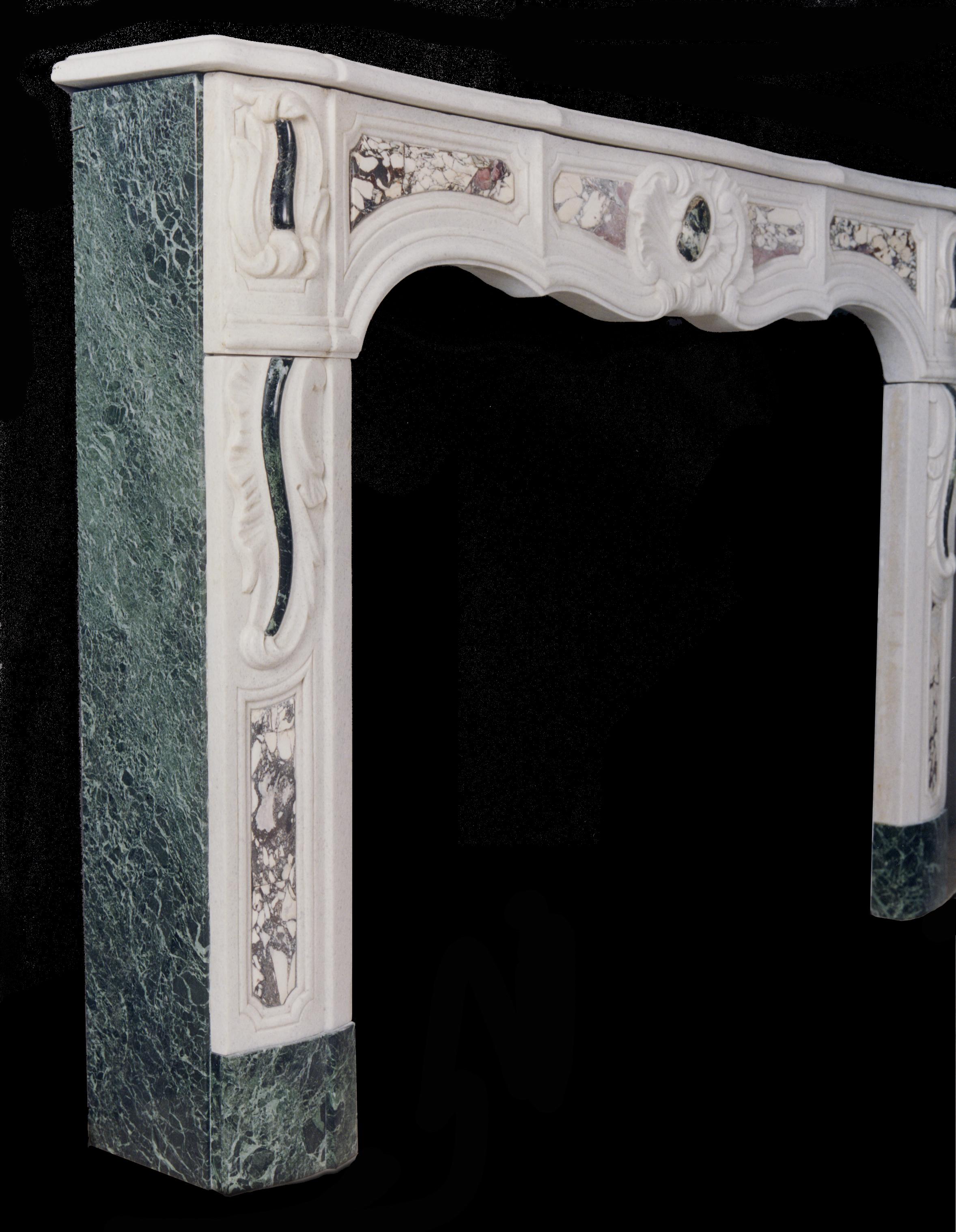An early 19th century French Provençale white marble fireplace inlaid with coloured marbles and carved with centre shell and foliage to jambs.

Shelf Width:	1715 mm      	67 ½
