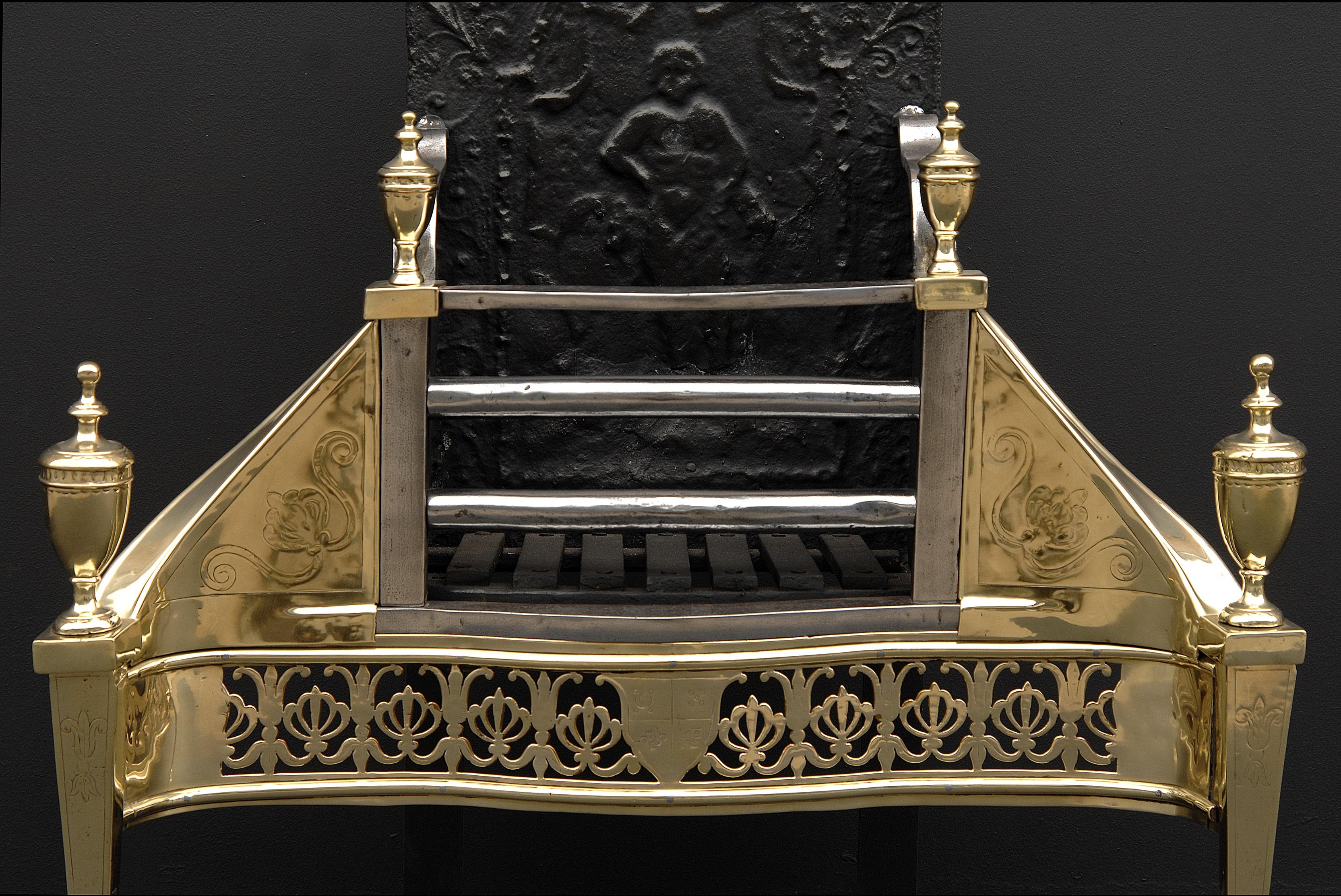 A good quality early 19th century Georgian brass and steel engraved firegrate, with serpentine shaped Athenian fret and shield to centre, square tapered legs surmounted by urn finials, engraved side wings, and ornamental cast iron shaped