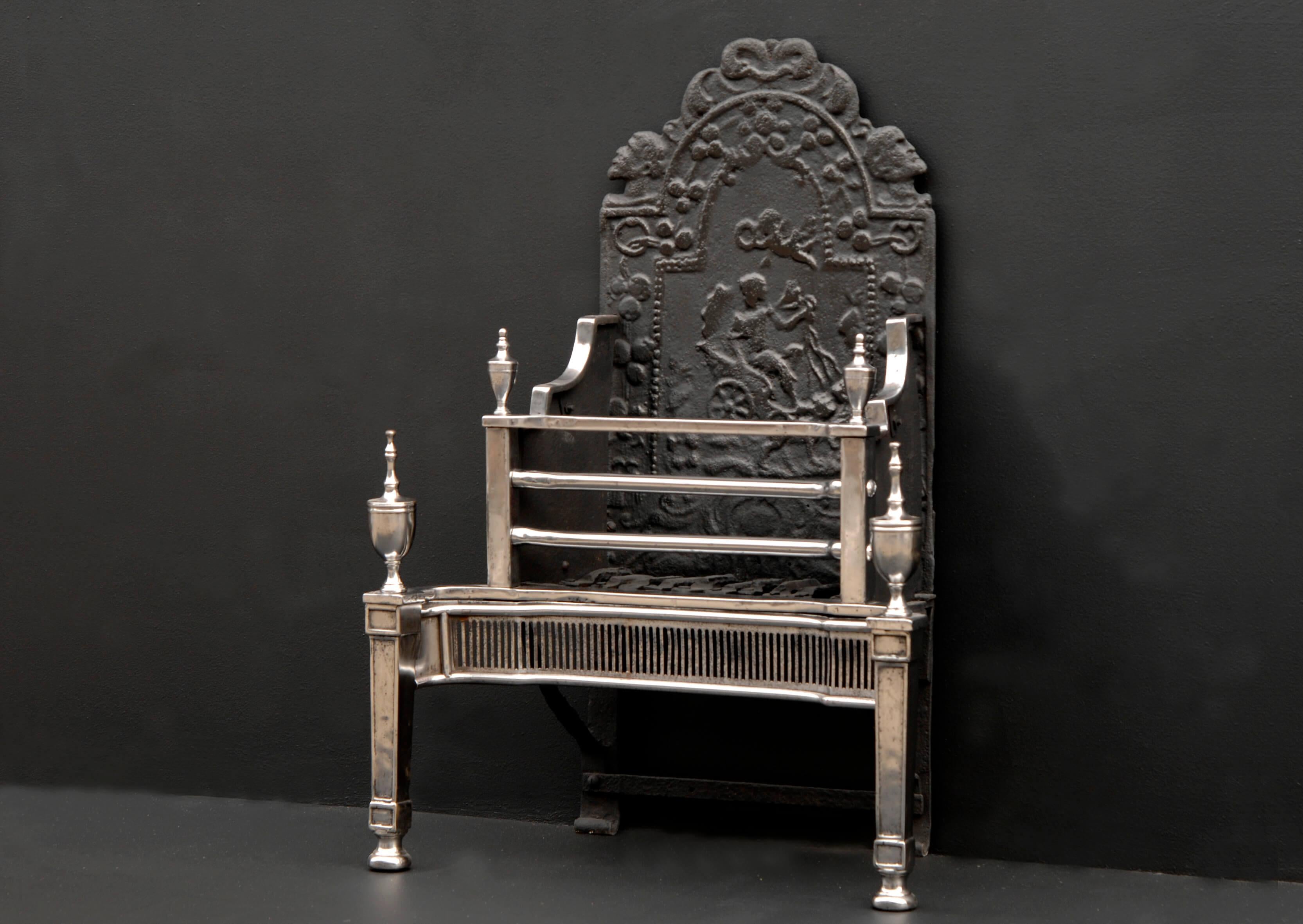 An early 19th century (possibly late 18th century) Georgian firegrate, with fluted steel fret, with square tapering panelled legs, urn finials and pattern back.

Width At Front:	690 mm      	27 ⅛