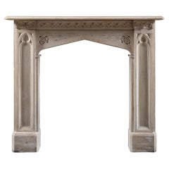 Antique An early 19th Century Gothic Revival chimneypiece carved in softly coloured lime