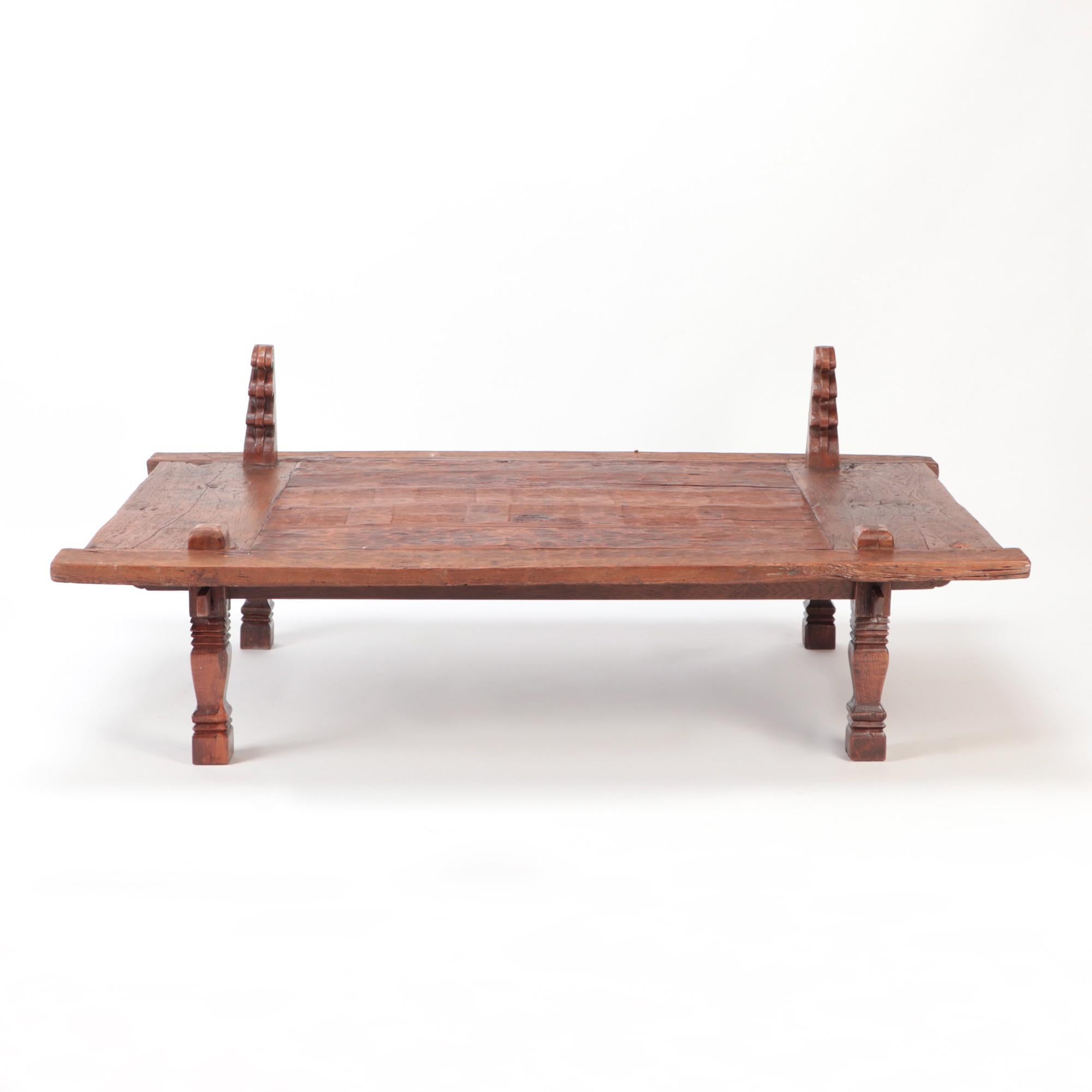 19th Century Indonesian coffee table authentically known as a sewing table. Made from solid teak, hand chiseled and hand carved. With a waxed finish.