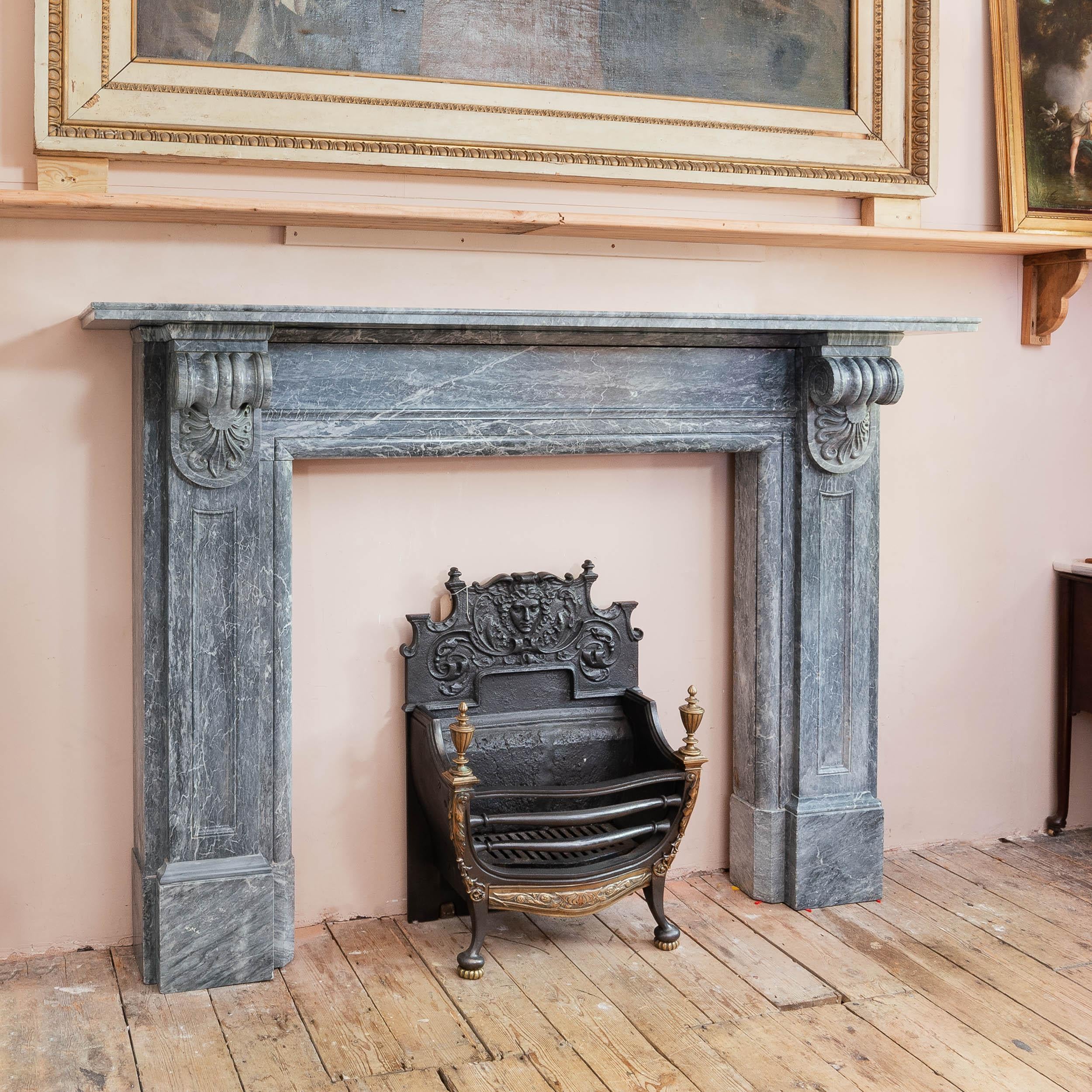 An Early nineteenth century Neo-Grecian Bardiglio marble fireplace, circa 1830, in the manner of Sir Jeffry Wyatville, of bold architectural form, with scrolled anthemion corbels supporting the lipped shelf, on block feet.

Dimensions:	130cm (51¼