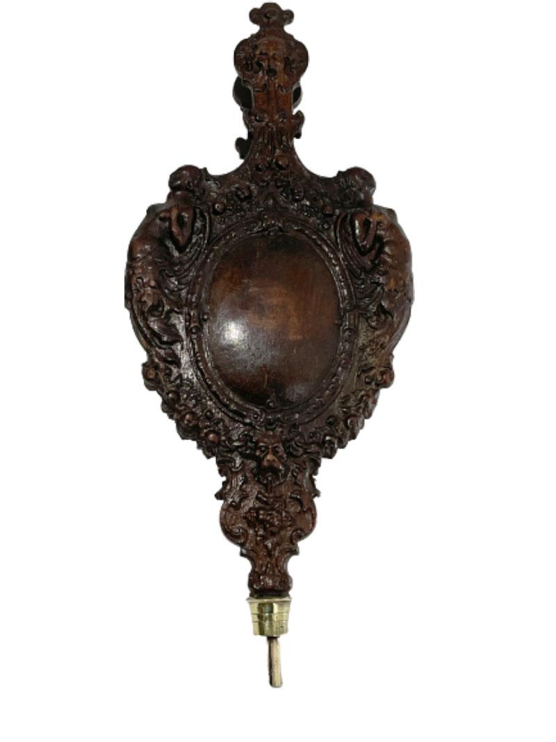 An early 19th century oak wooden bellows richly carved with a Mythological scene

A mythological scene of Salacia (Neptune's wife) depicted centrally in an oval medallion and mermaids, left and right. At the handle of the bellows Neptune and below
