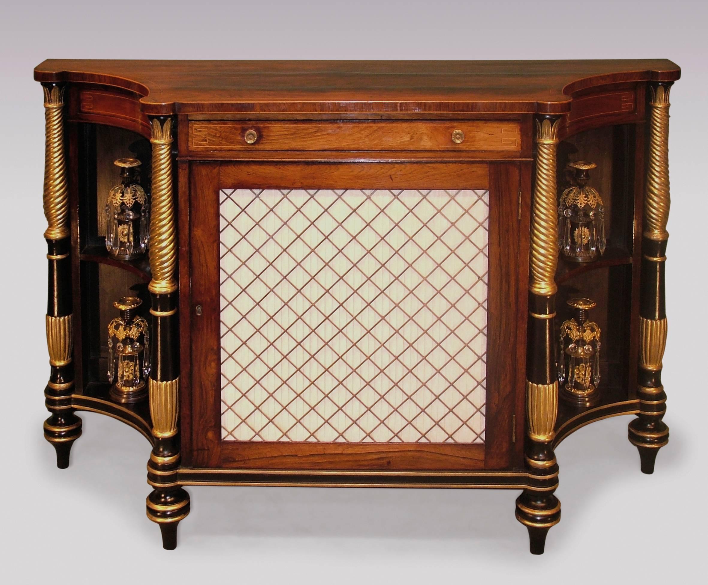 An attractive early 19th century Regency period rosewood Chiffonier, boxwood strung throughout, having concave top with rounded corners, above frieze drawer and central silk pleated brass grille door, flanked by carved giltwood and black painted