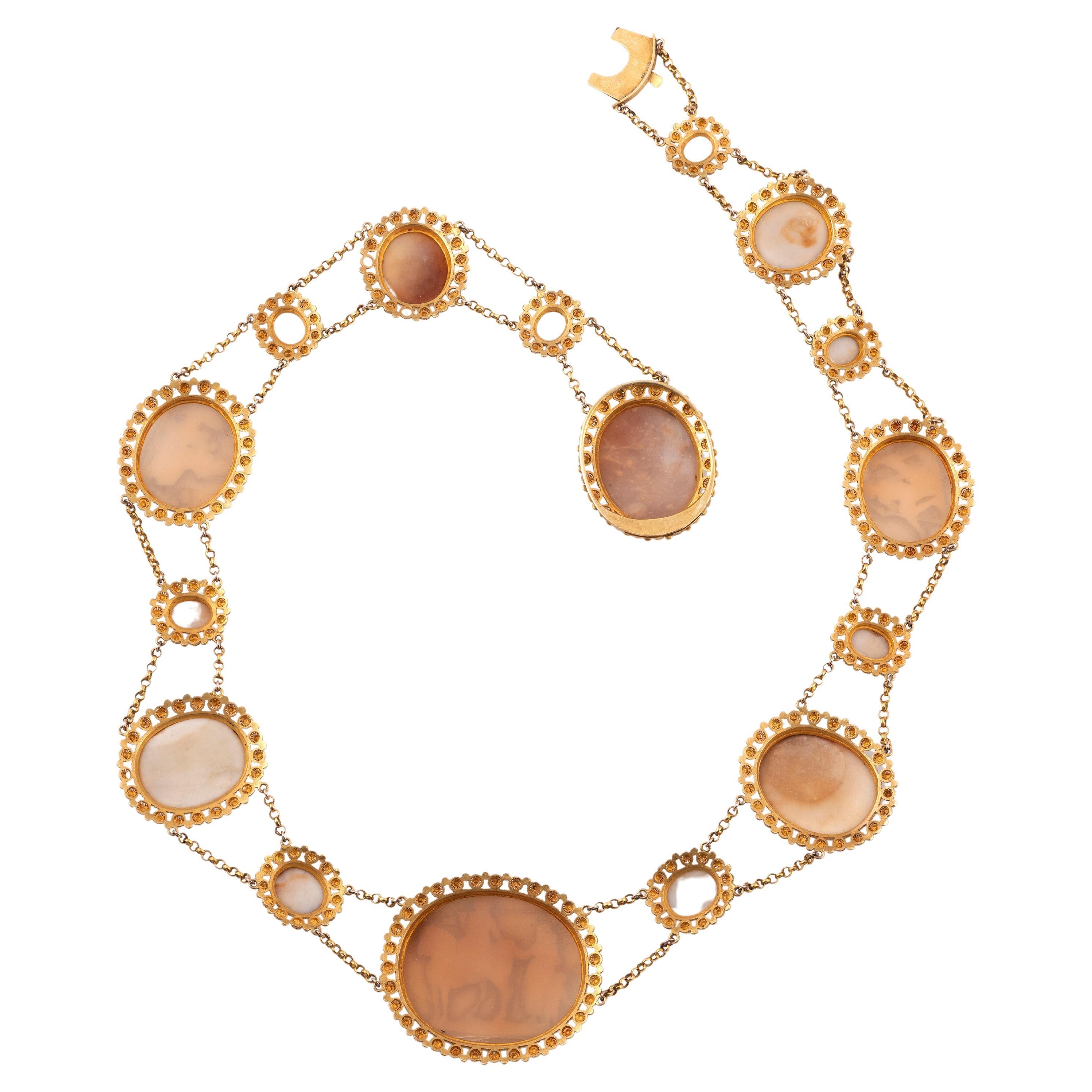 An early 19th century shell cameo necklace, the shell cameos set in gold cannetille mounts with pellet decoration, necklace 46cm long
Weight:50.5gr.