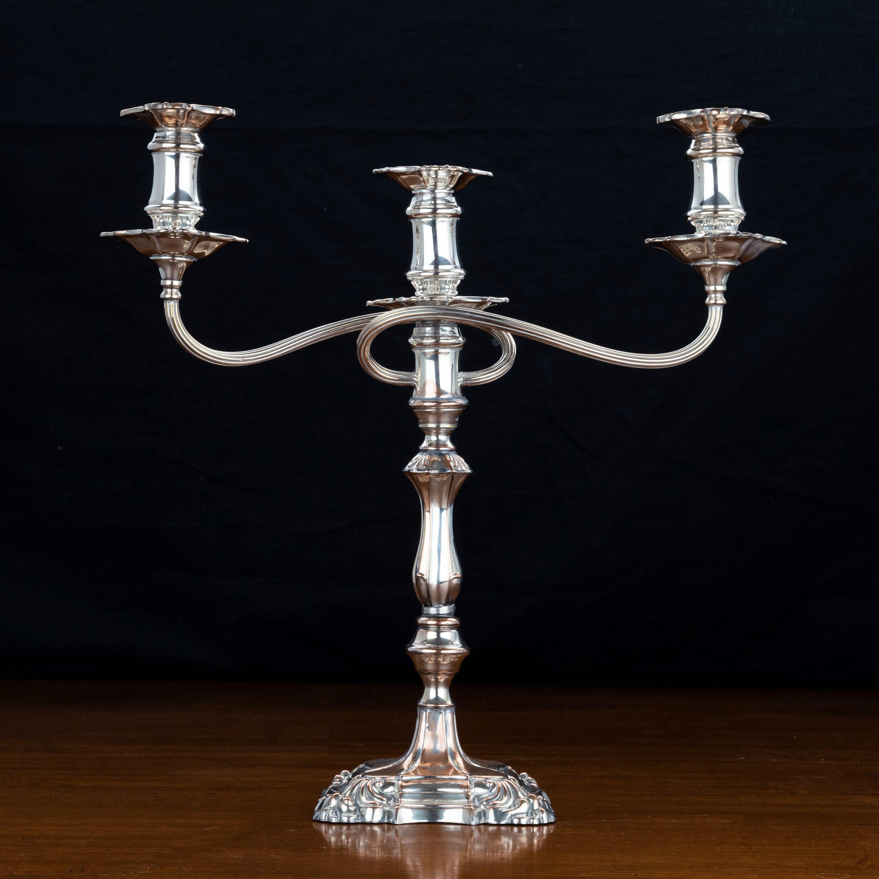 An early 19th century three-armed candelabra. Of elaborate form on a swept square base.