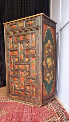 An early 19th century Tibetan hand painted pine armoire