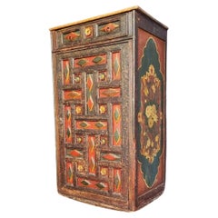 An early 19th century Tibetan hand painted pine armoire