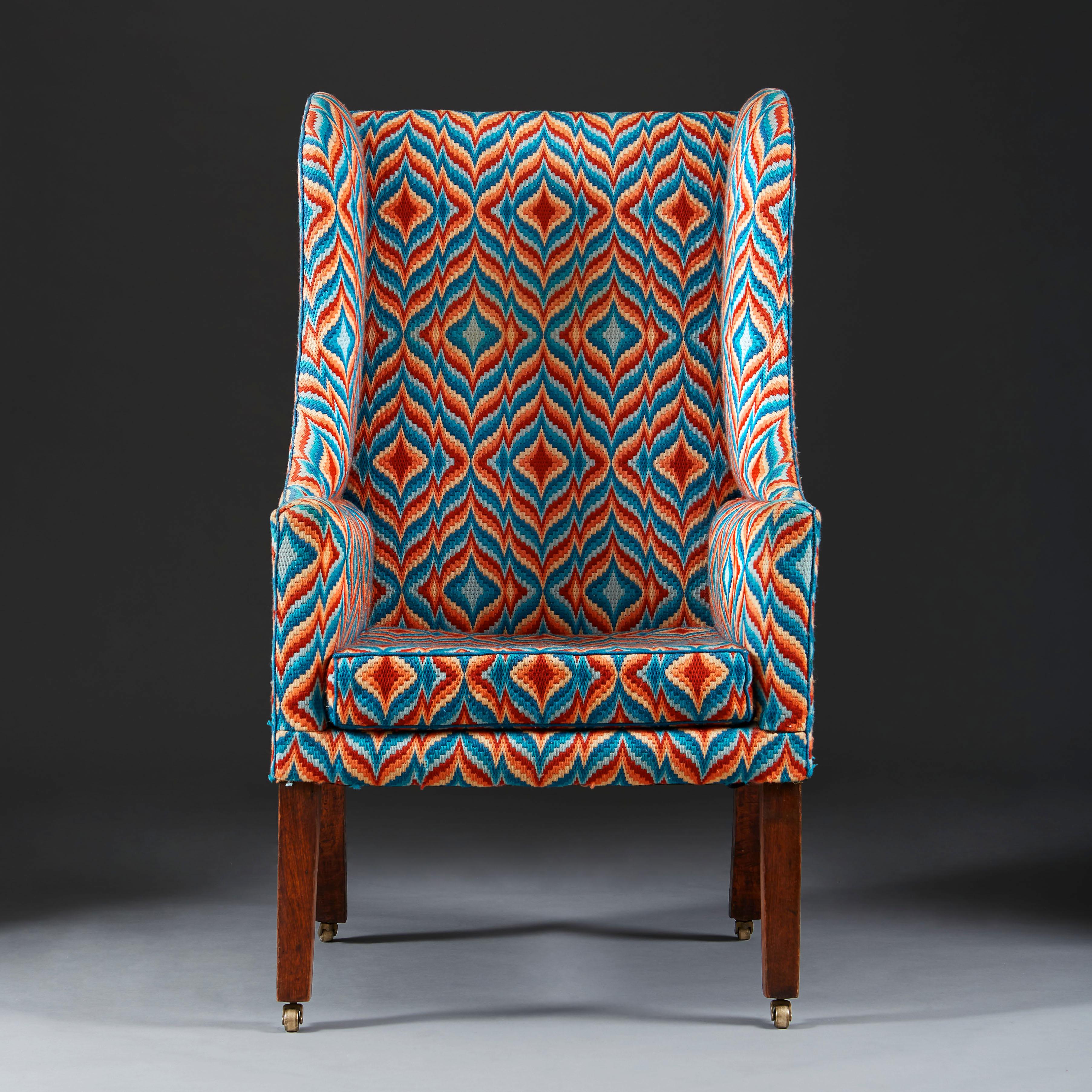 A fine early 19th century wingback armchair with mahogany legs, with bargello flame stitch needlework.

The chair, 19th century. The needlework, mid-20th century.

   