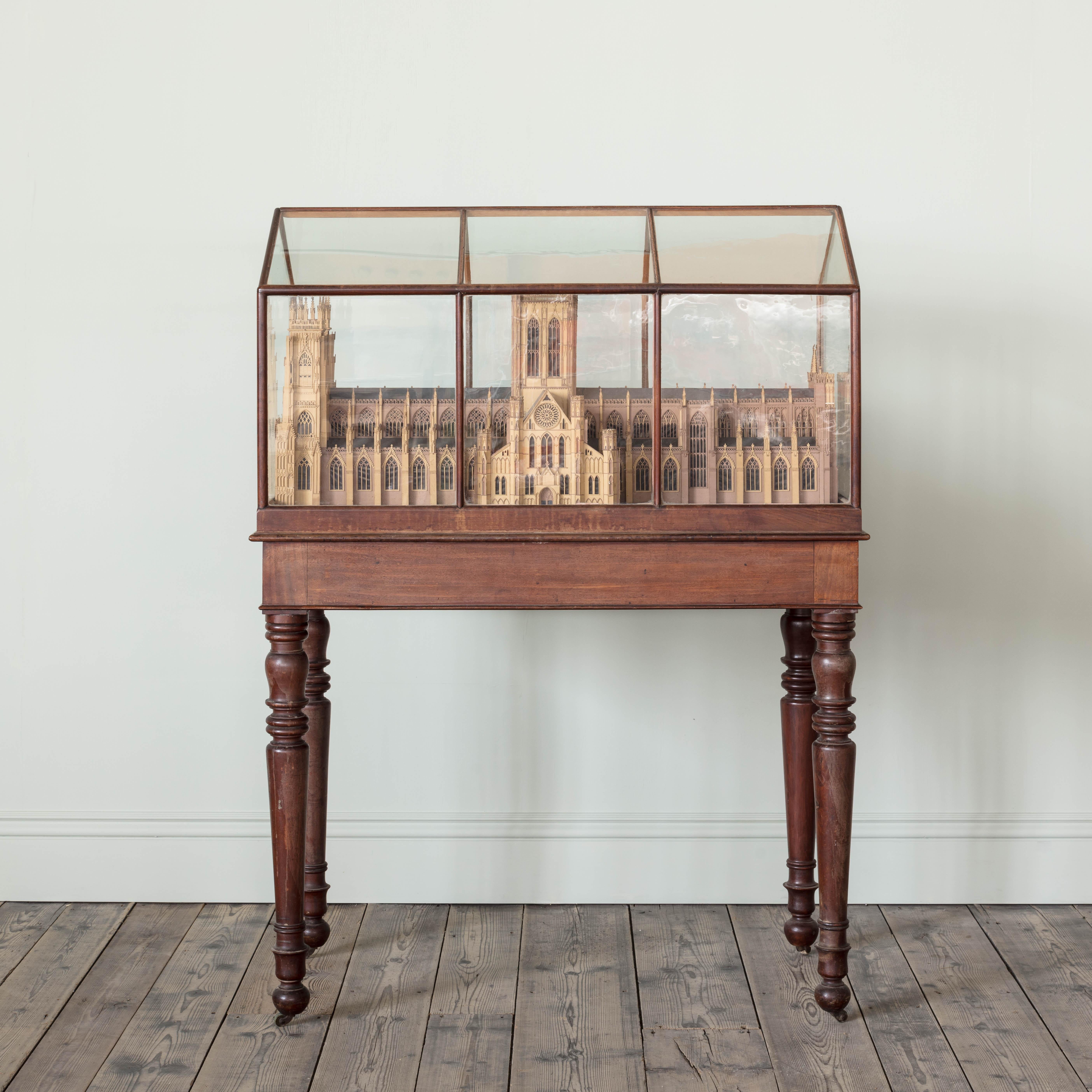 An early 19th century wooden and paper model of York Minster. Housed within its original mahogany and glass case on stand, English, circa 1835.
