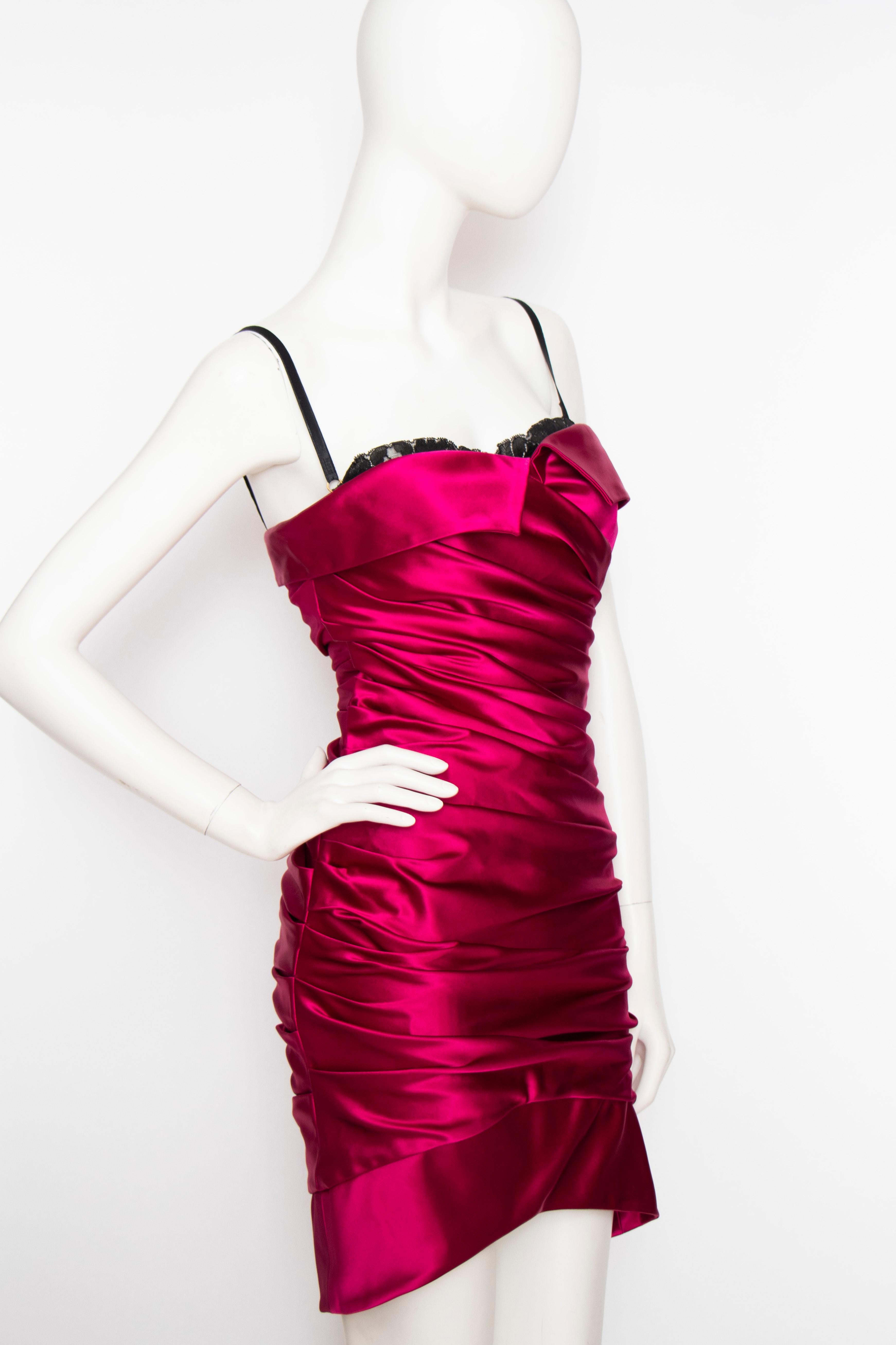 An early 2000s Dolce & Gabbana pink satin cocktail dress with stunning ruching and contrasting black lace bra. 

The size of the dress corresponds to a modern size Small. 