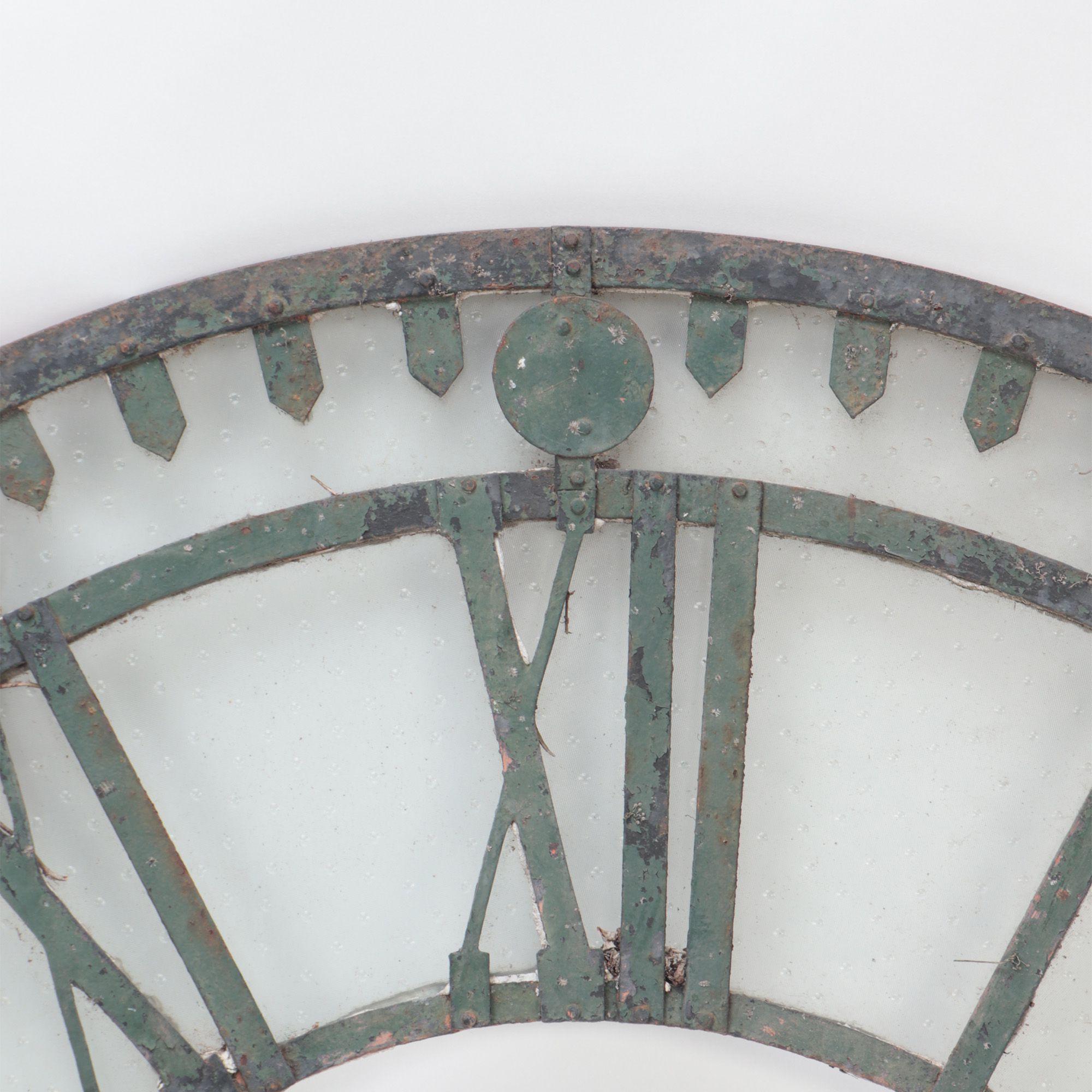 An early 20th C cast iron and glass clock face ornament, circa 1900.