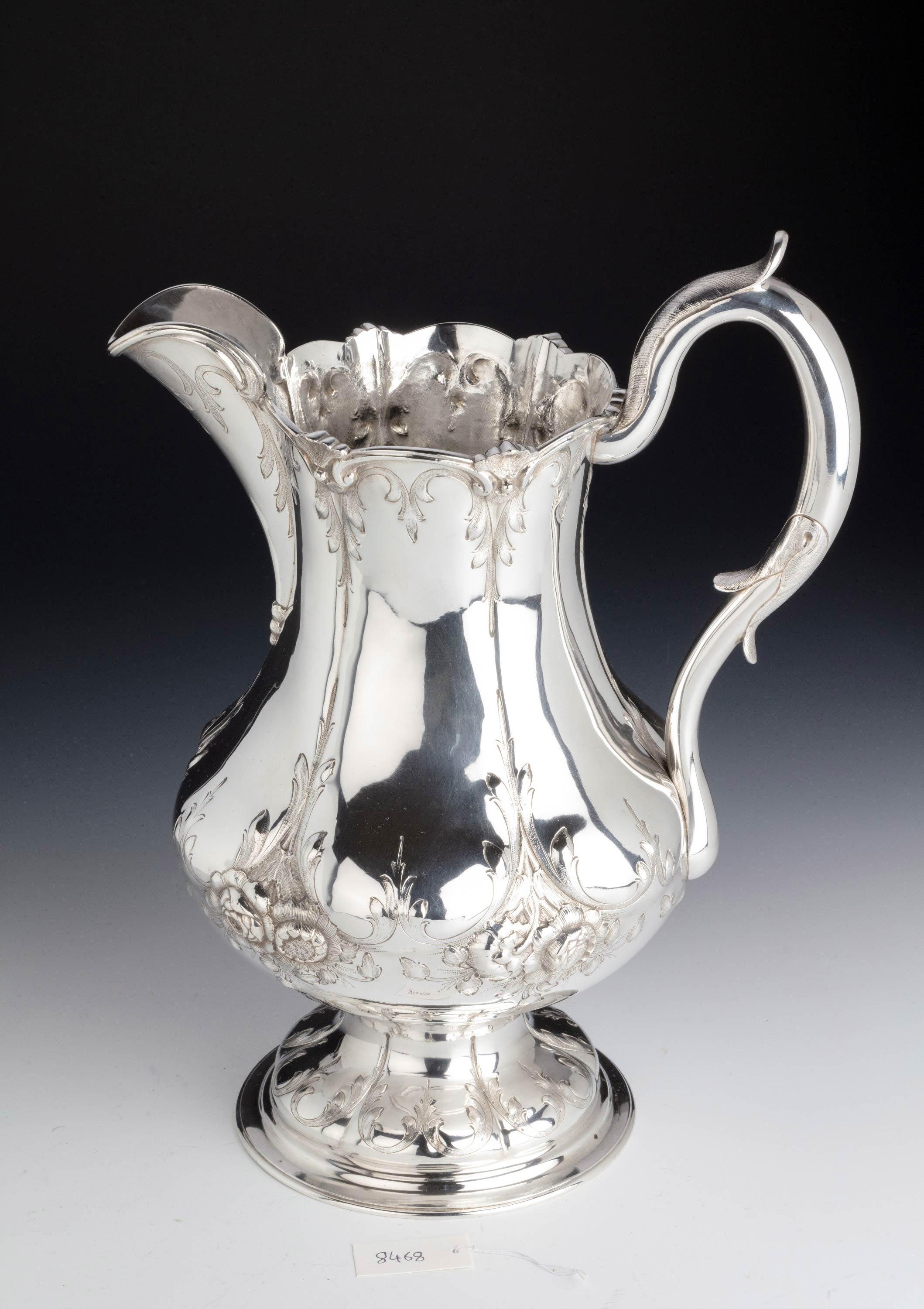 A handsome large American silver beer or water jug. Boston silver. With a finely carved top edge and scrolled handle. In excellent overall condition.