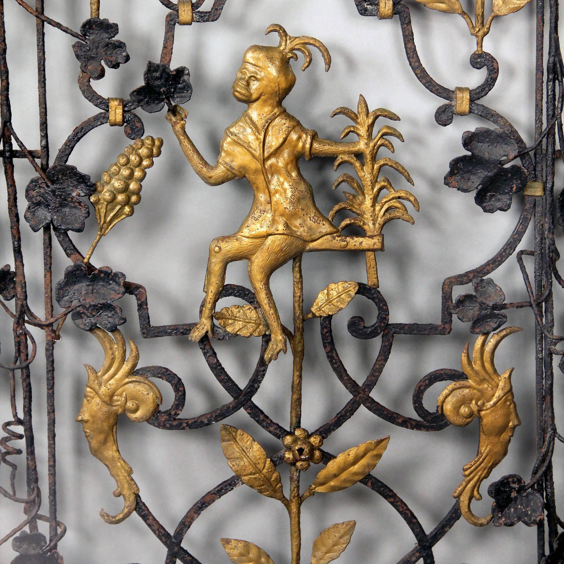 An interesting early 20th century Art Deco gold painted two-door iron gate

Each door is centered with a gilded sitting monkey above two male masks, the tops with swans and a crawling monkey, centered with a bowl of fruit. The gates are entwined