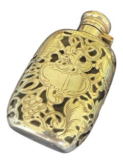 An early 20th century art nouveau style silver overlaid glass flask