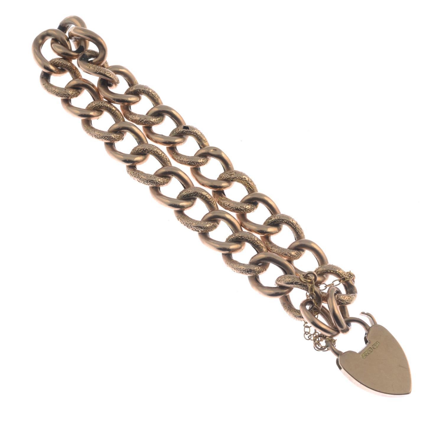 Designed as a graduated textured and polished curb-link chain, with heart-shape padlock clasp. Length 18cms. Weight 12.3gms. 
Padlock clasp with maker's mark 'J.G&S'