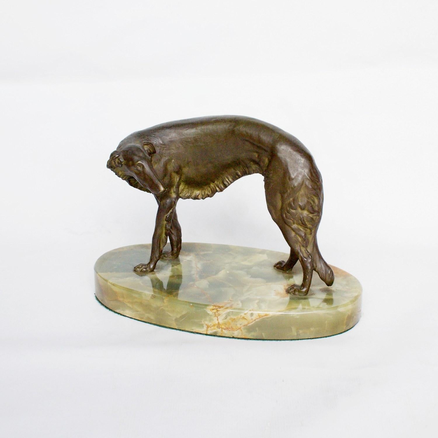 An early 20th century, rich brown bronze sculpture depicting a Borzoi dog looking timidly behind him. Signed Bormann to outside of body with a foundry stamp found alongside. Set over original green onyx base. 

Artist: Wilhelm Bormann
