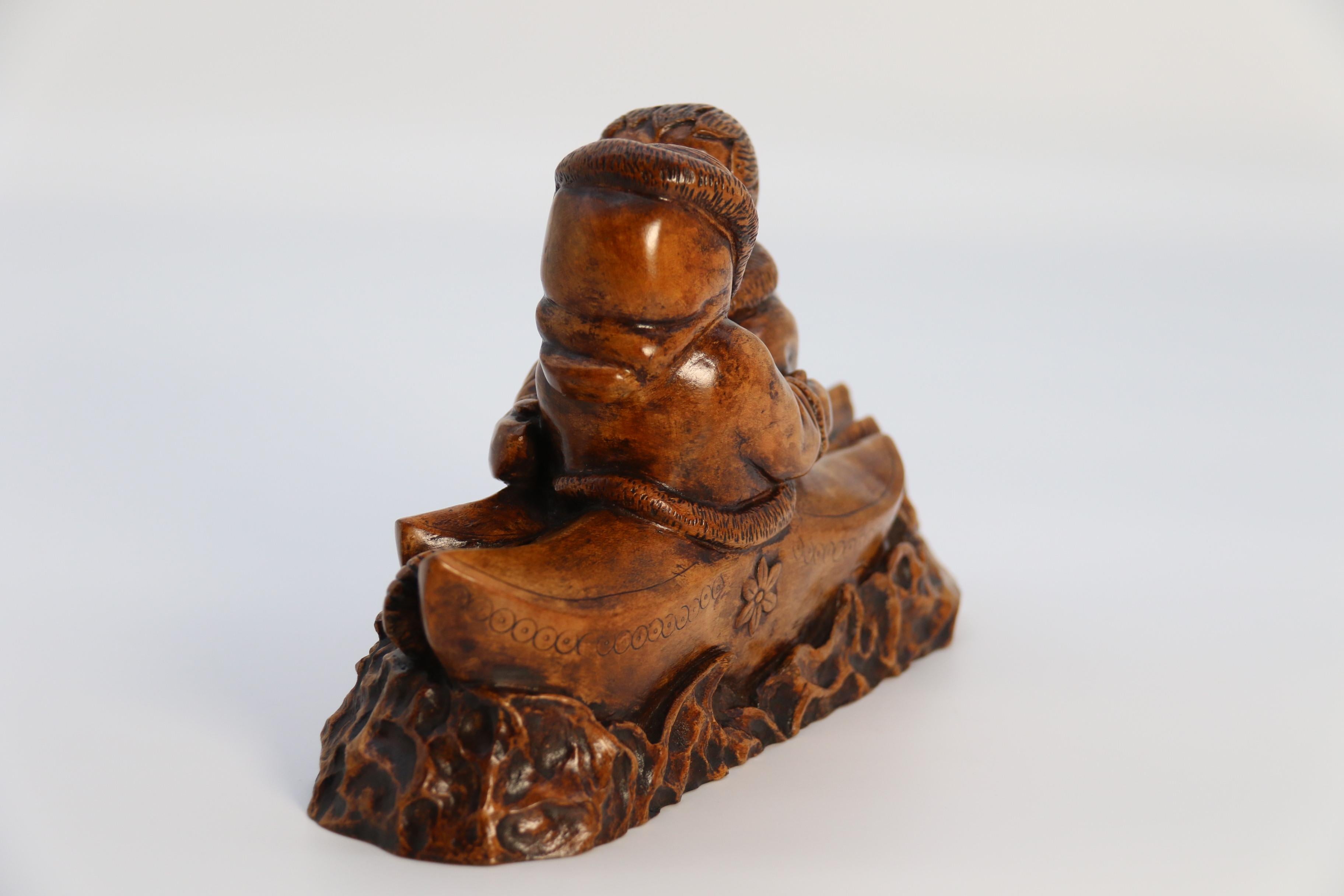An early 20th century Canadian folk art maple wood carved Inuit figure group For Sale 2