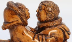 An early 20th century Canadian folk art maple wood carved Inuit figure group