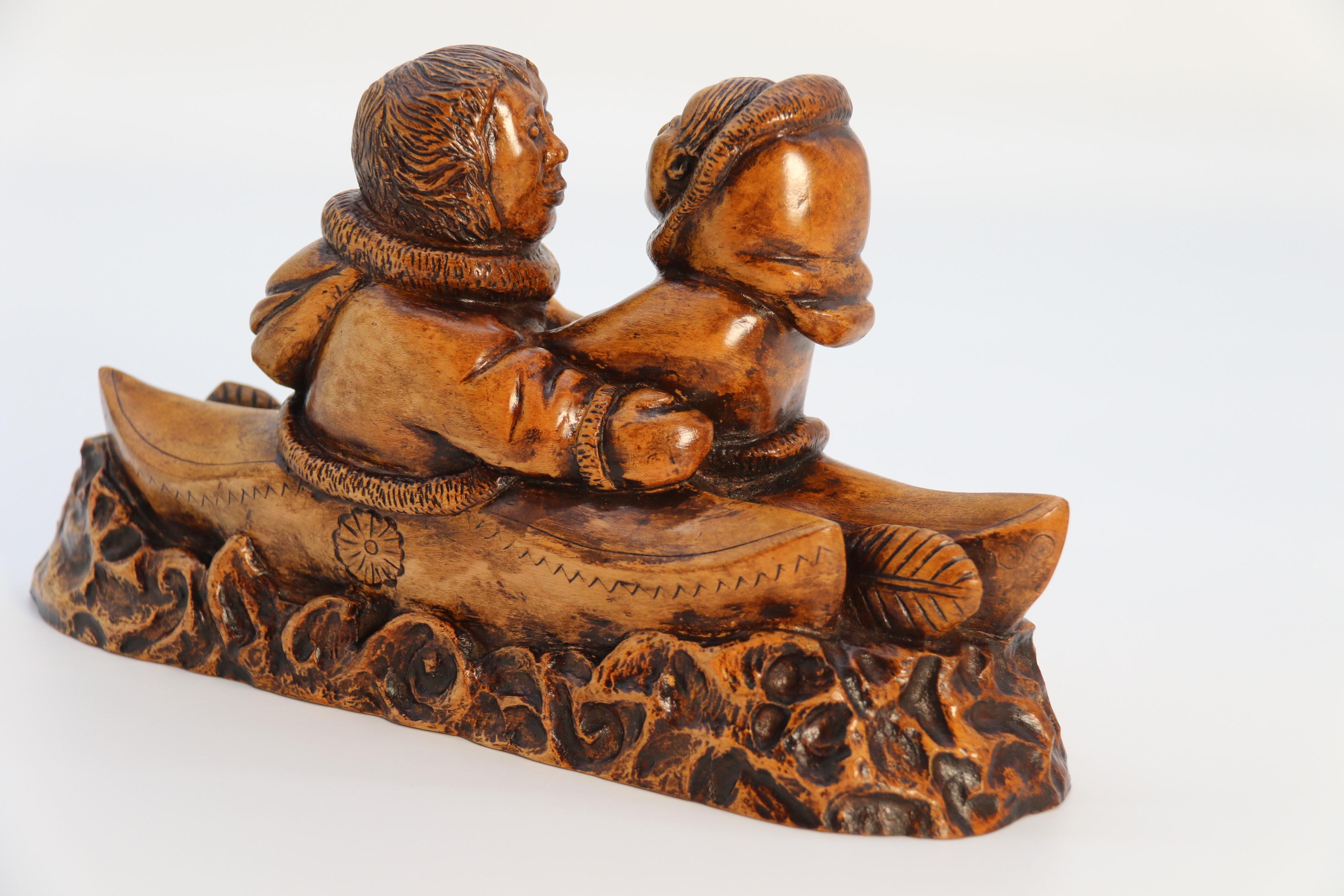 Maple An early 20th century Canadian folk art maple wood carved Inuit figure group For Sale