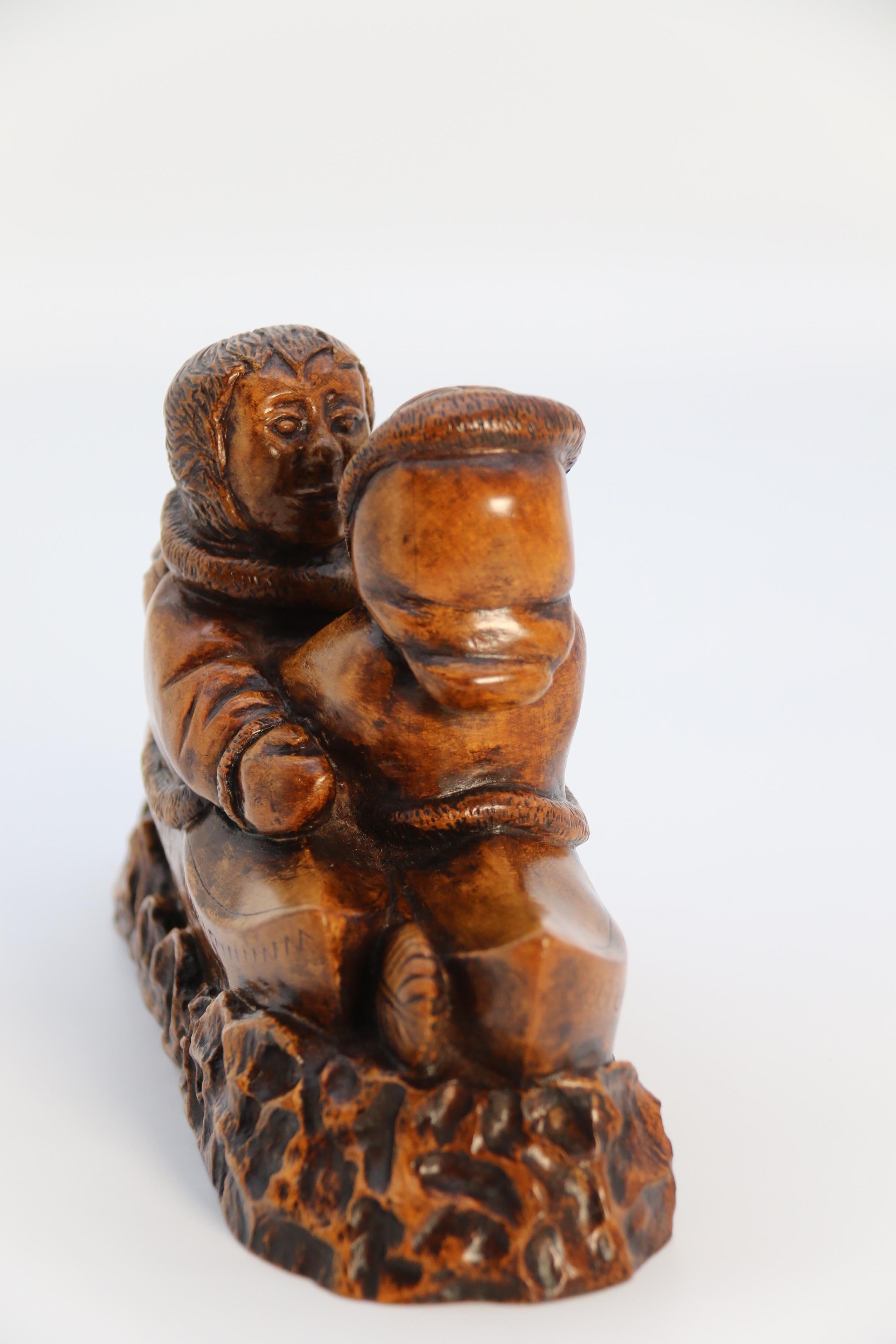 An early 20th century Canadian folk art maple wood carved Inuit figure group For Sale 2