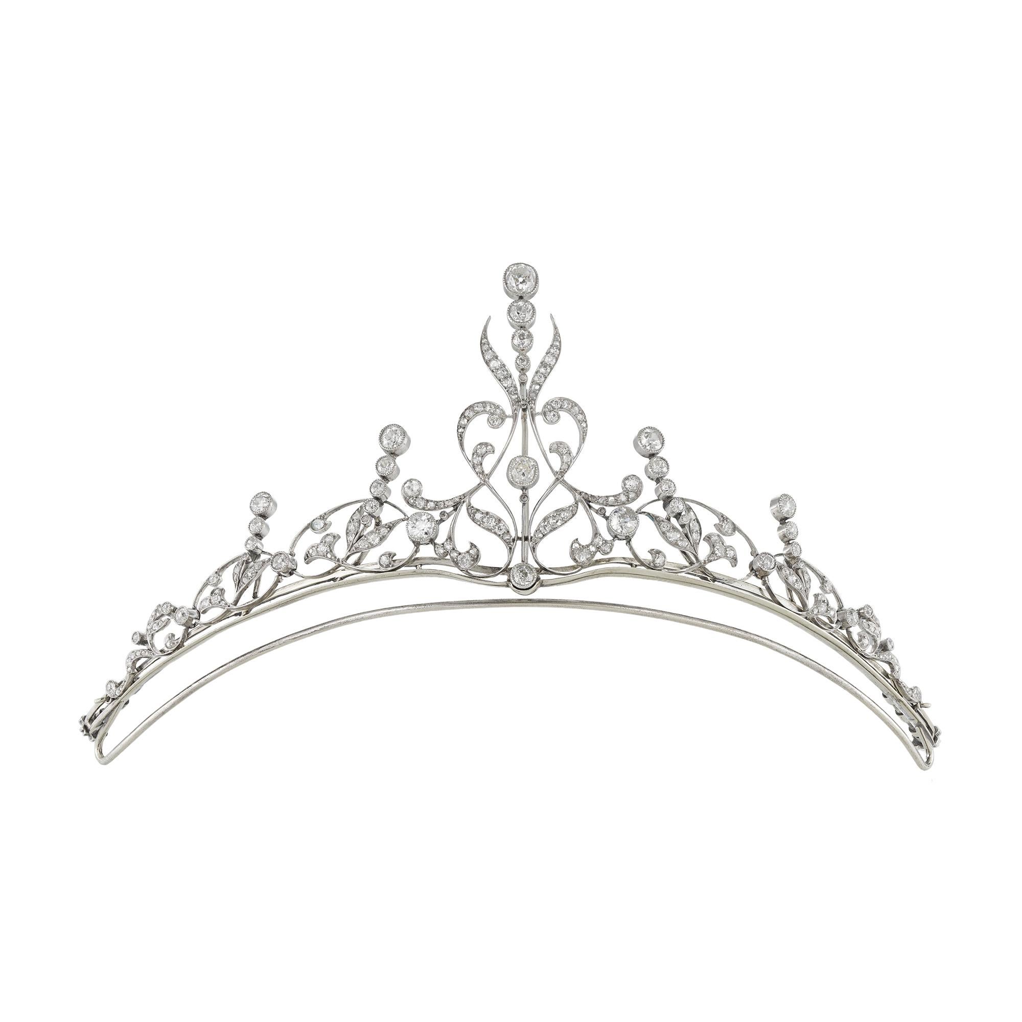 An early 20th century diamond-set tiara/necklace by Skinner & Co, the five principal old-cut diamonds estimated to weigh a combined total of 2 carats, each rub over millegrain-set to a scroll and foliate design embellished with small rose and old