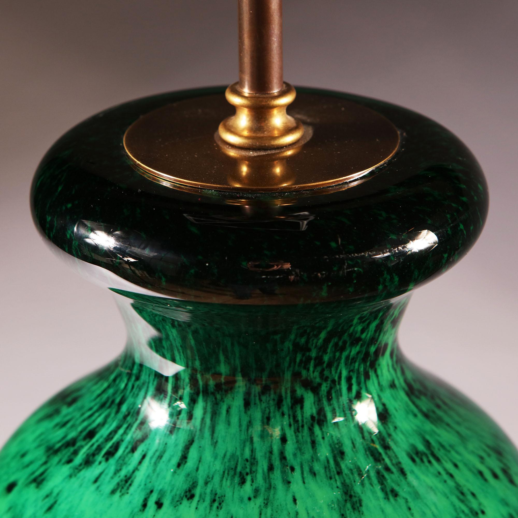 An early 20th century green art glass vase, with dappled green decoration, now converted as a lamp. Signed to the base A Masson.

Please note: Lampshade not included.

Currently wired for the UK.  