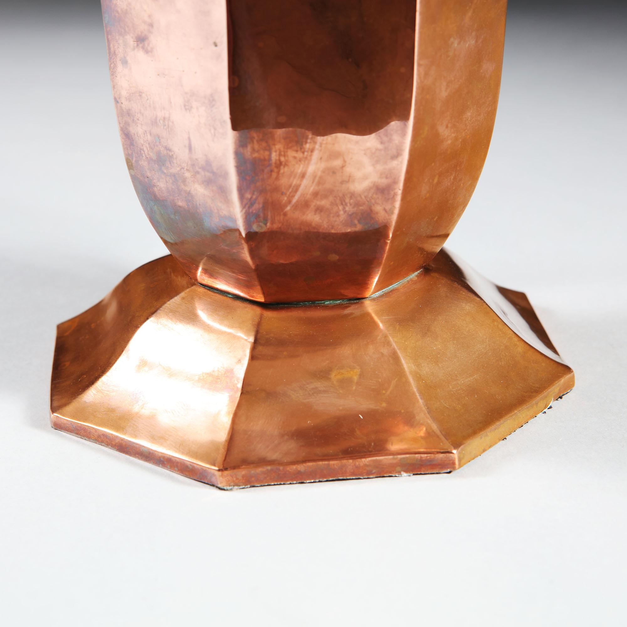 An early 20th century French copper vase of octagonal form, with a flared neck and raised base, now mounted as a table lamp.

Please note: Lampshade not included.

Currently wired for the UK.