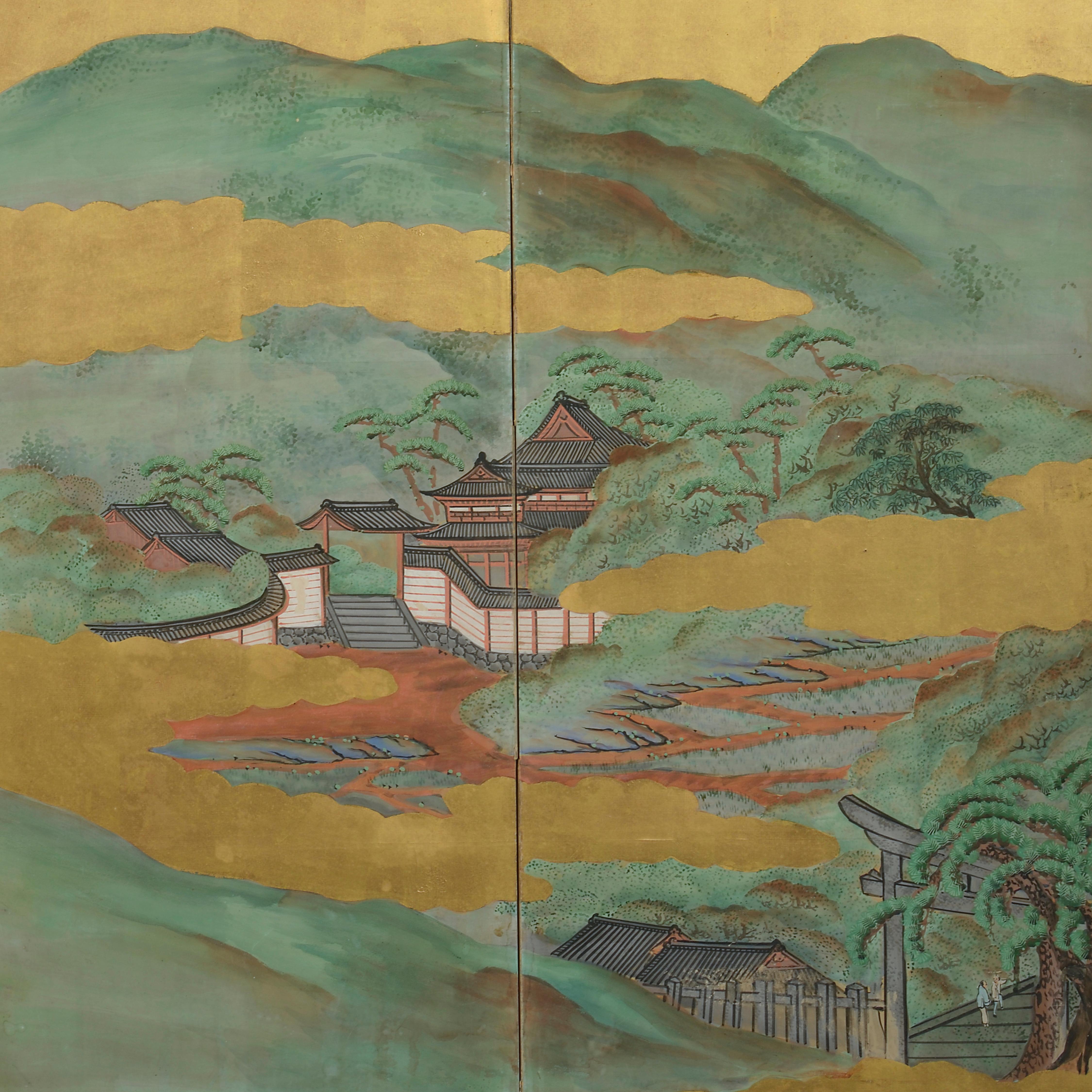An early 20th century six fold paper screen, depicting an imaginary mountainous landscape with temples and pagodas depicted in the foreground.