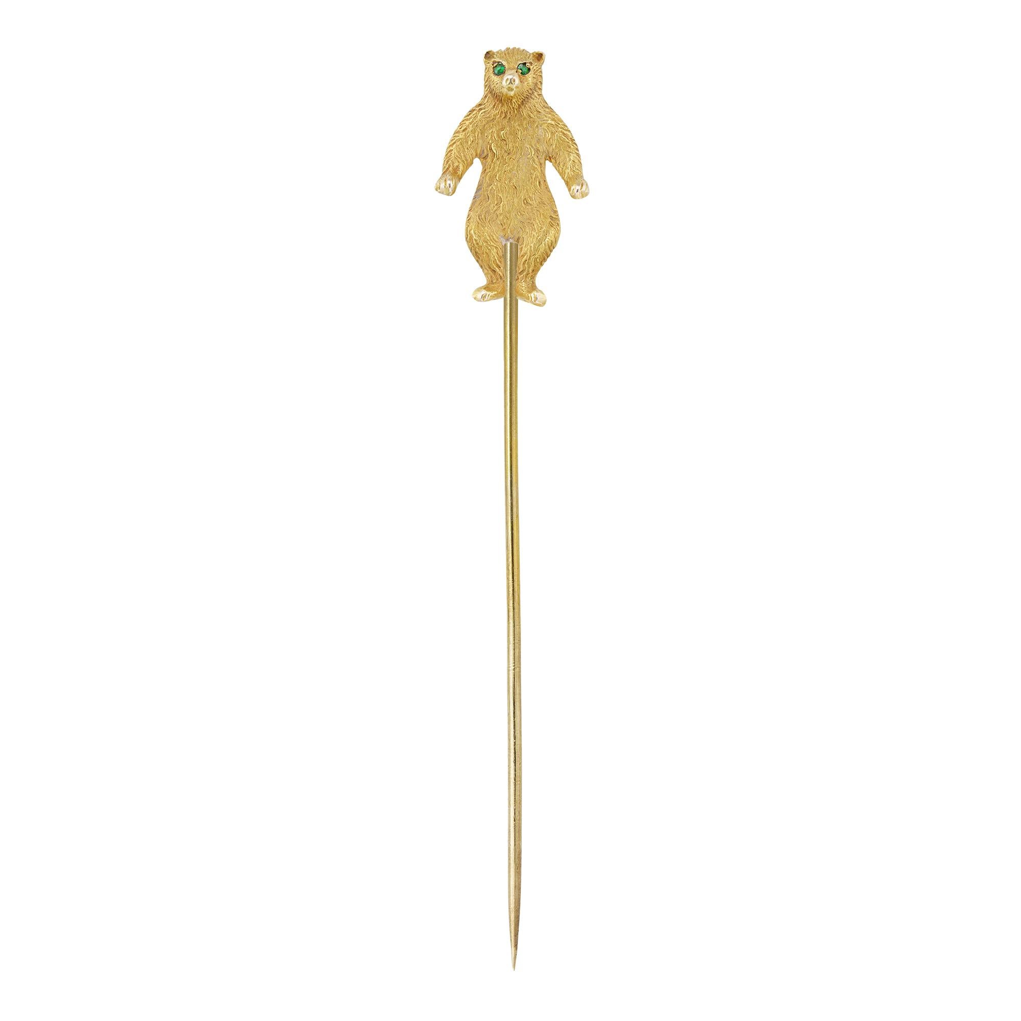 An early 20th century gold bear stickpin, the body with finely engraved details, the eyes set with demantoid garnet, all mounted in 14ct yellow gold, circa 1910, measuring 2.1 x 1.2cm, the pin measuring 6cm long, gross weight 2.4 grams.

This