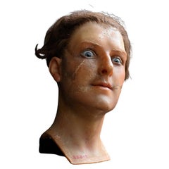 An early 20th century Paris wax mannequin head with glass eyes