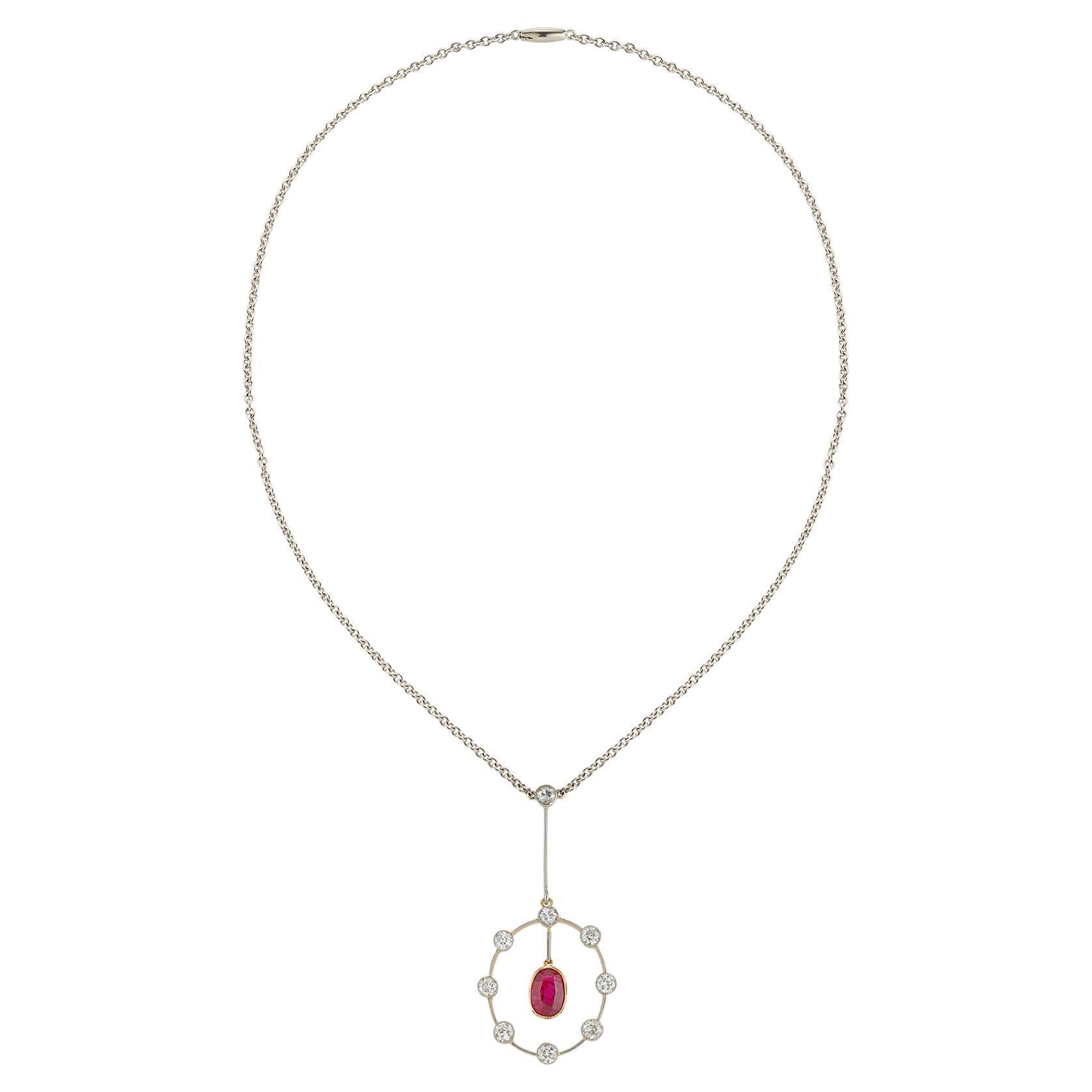 An early 20th century ruby and diamond pendant, the oval faceted ruby weighing 1.56 carats accompanied by The Gem & Pearl laboratory stating to be Burmese origin with no indication of heating, rub-over millegrain-set in yellow gold and suspended