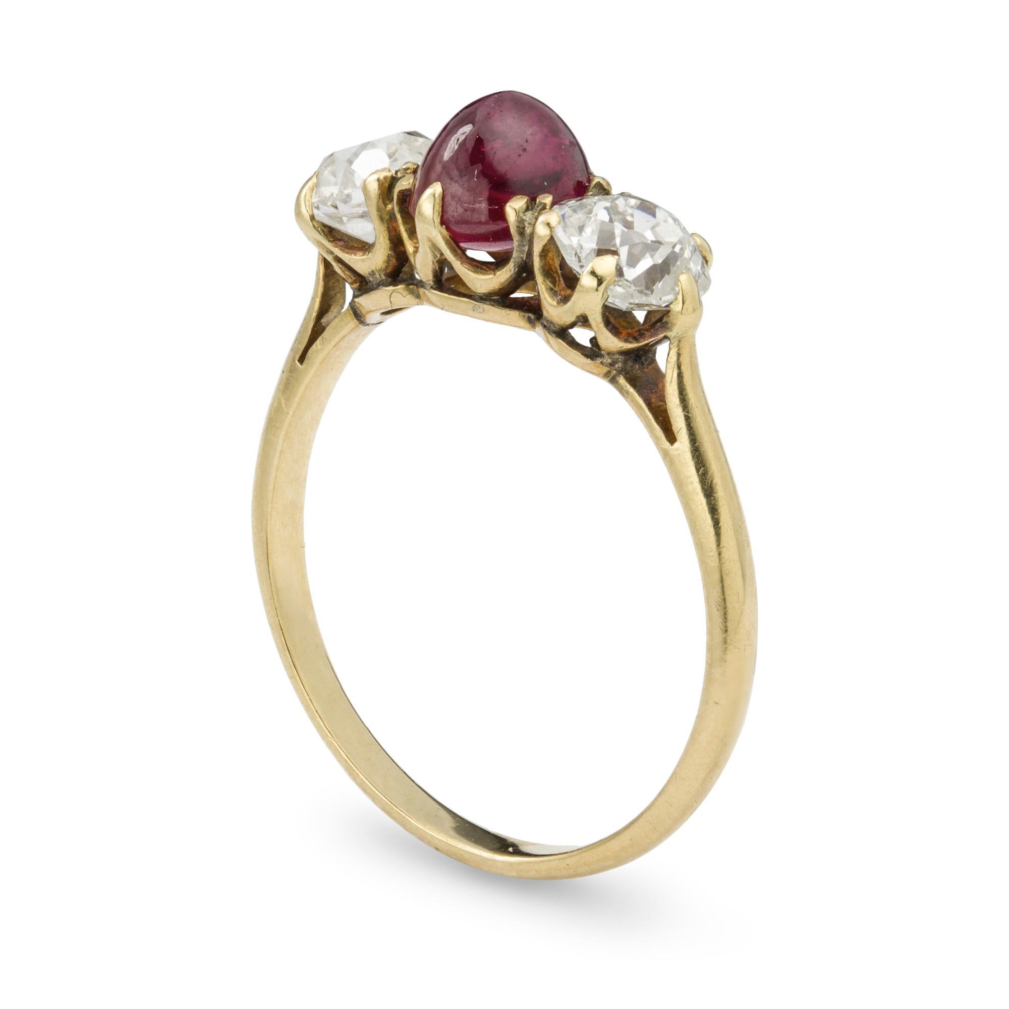 An early 20th Century ruby and diamond three stone ring, the central cabochon-cut ruby weighing 1.72 carats, accompanied by GCS Report stating to be of Burmese origin with no indication of heating, flanked by two old brilliant-cut diamonds weighing