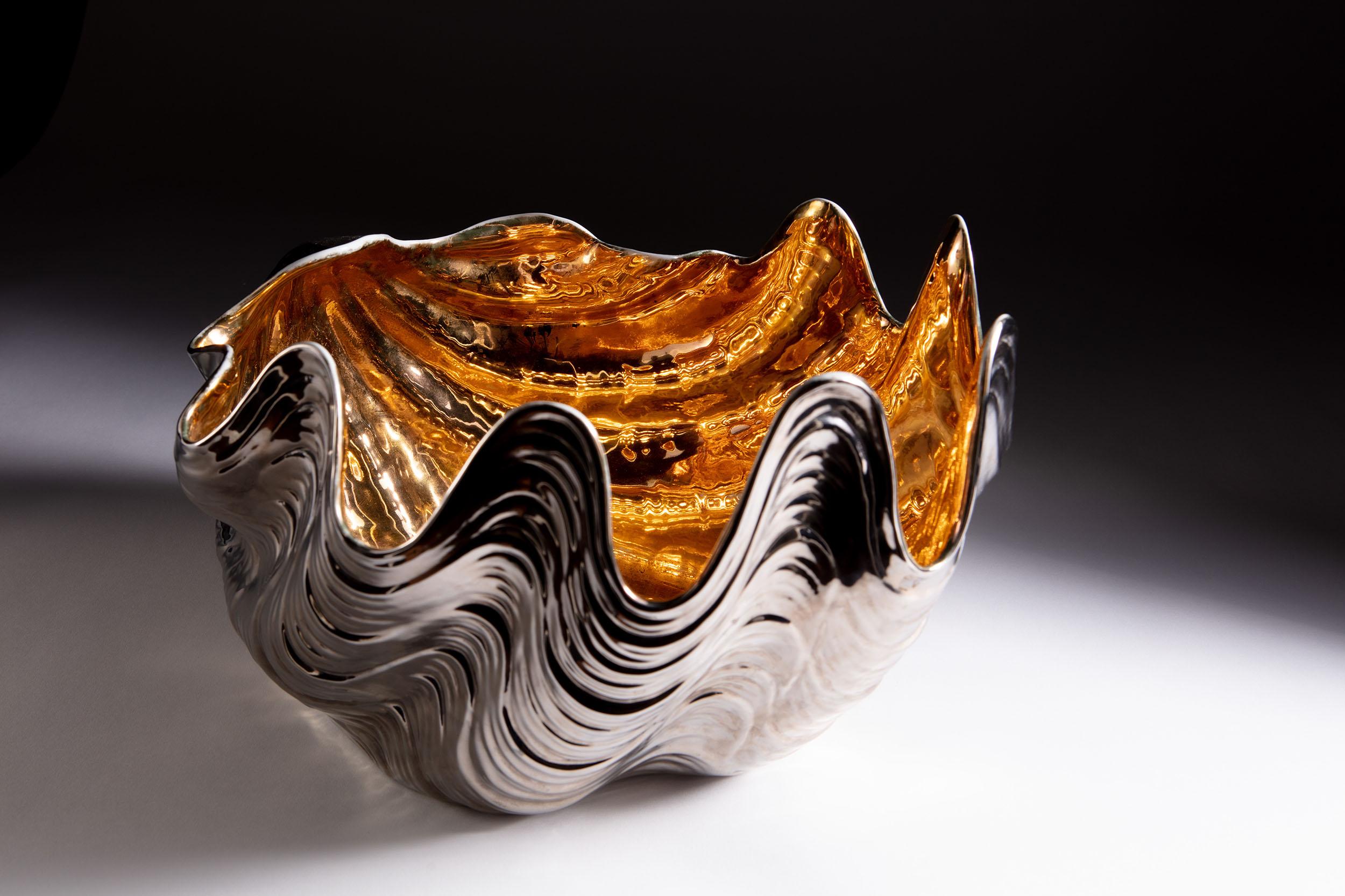 A fine early 20th century porcelain bowl of large scale in the form of a clam shell, with silvered outer and gilt interior.