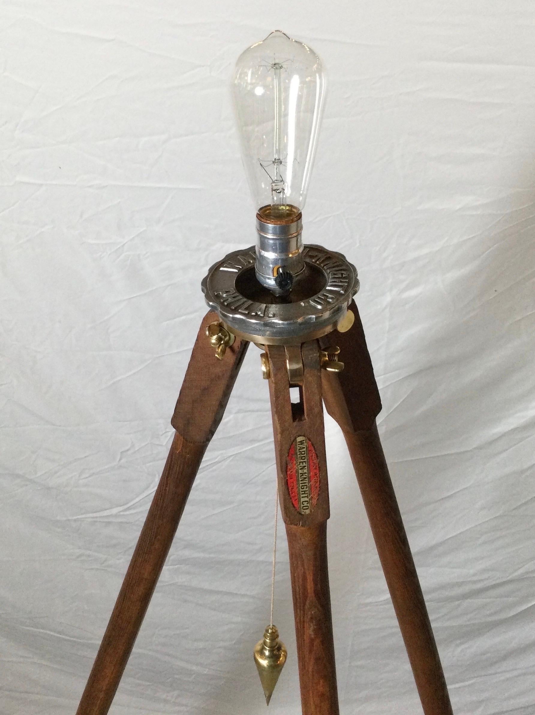 A 1930's wood surveyors tripod now electrified. Made by the Warren Knight Co. Philadelphia, PA. The size is adjustable 56 inches tall.