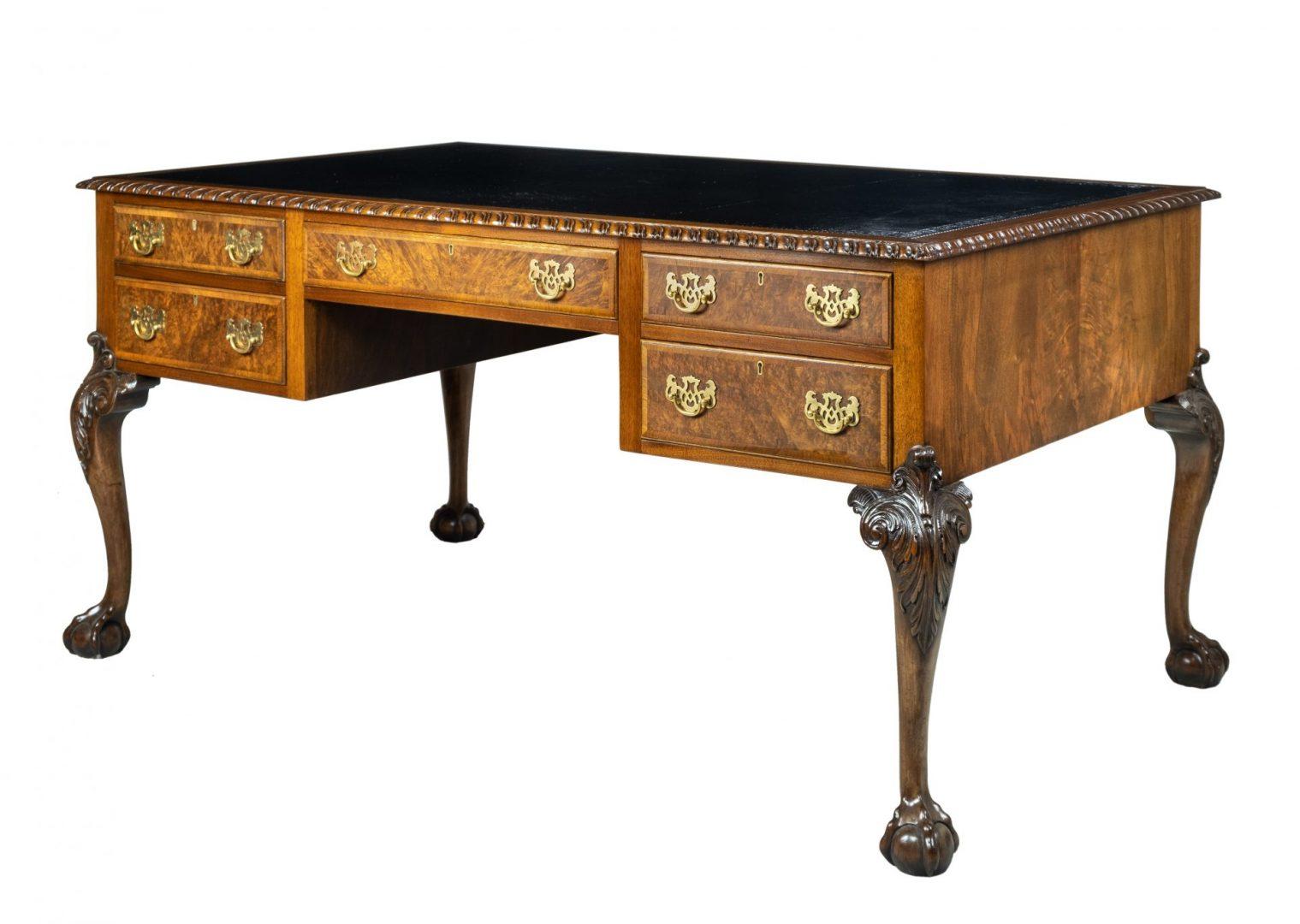 An early 20th century walnut desk, with tooled leather writing surface, five drawers and raised on cabriole legs, signed “Waring & Gillow” in the Chippendale style


Gillows of Lancaster and London, also known as Gillow & Co., was an English
