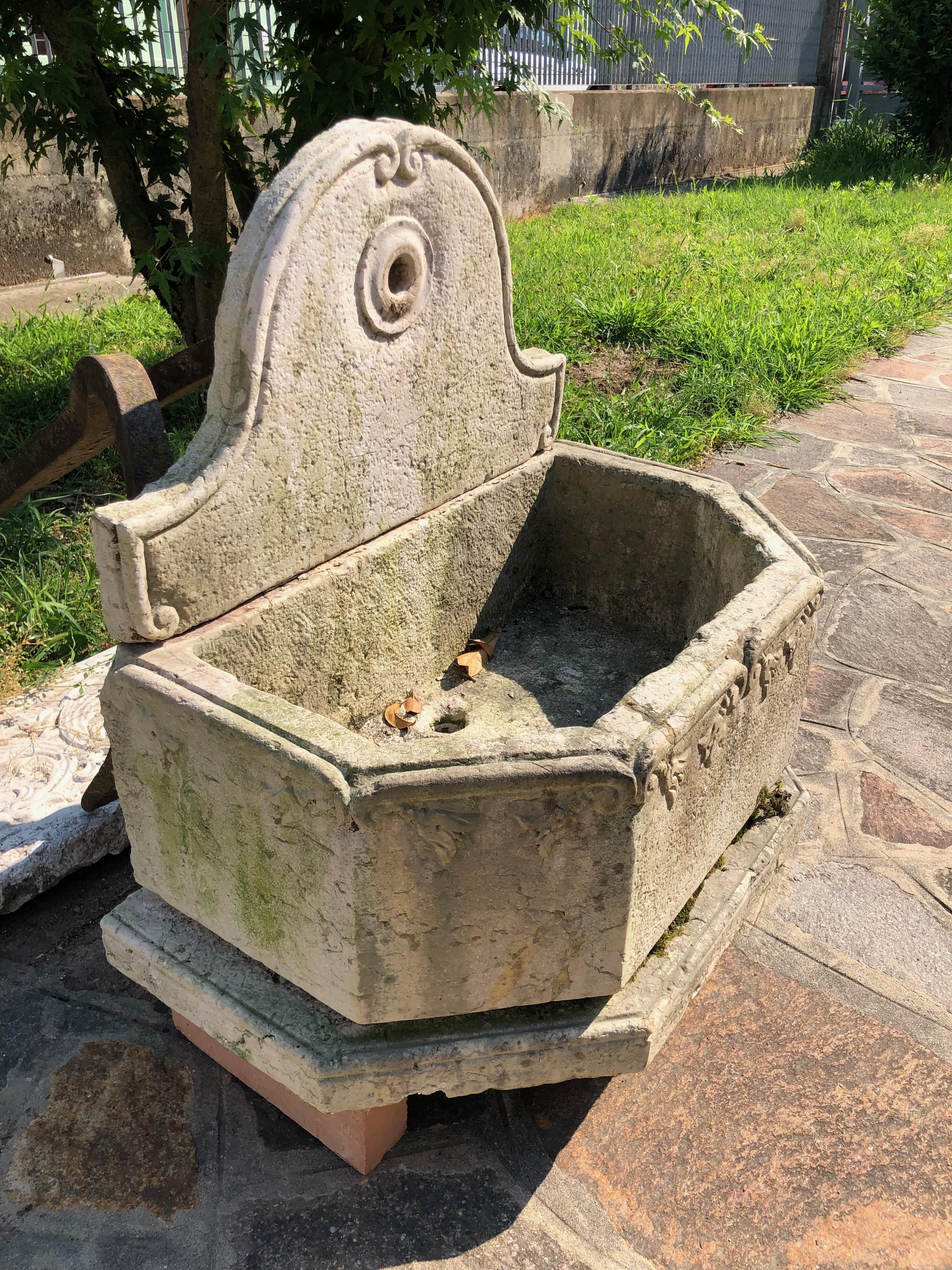 A small garden fountain entirely in marble 