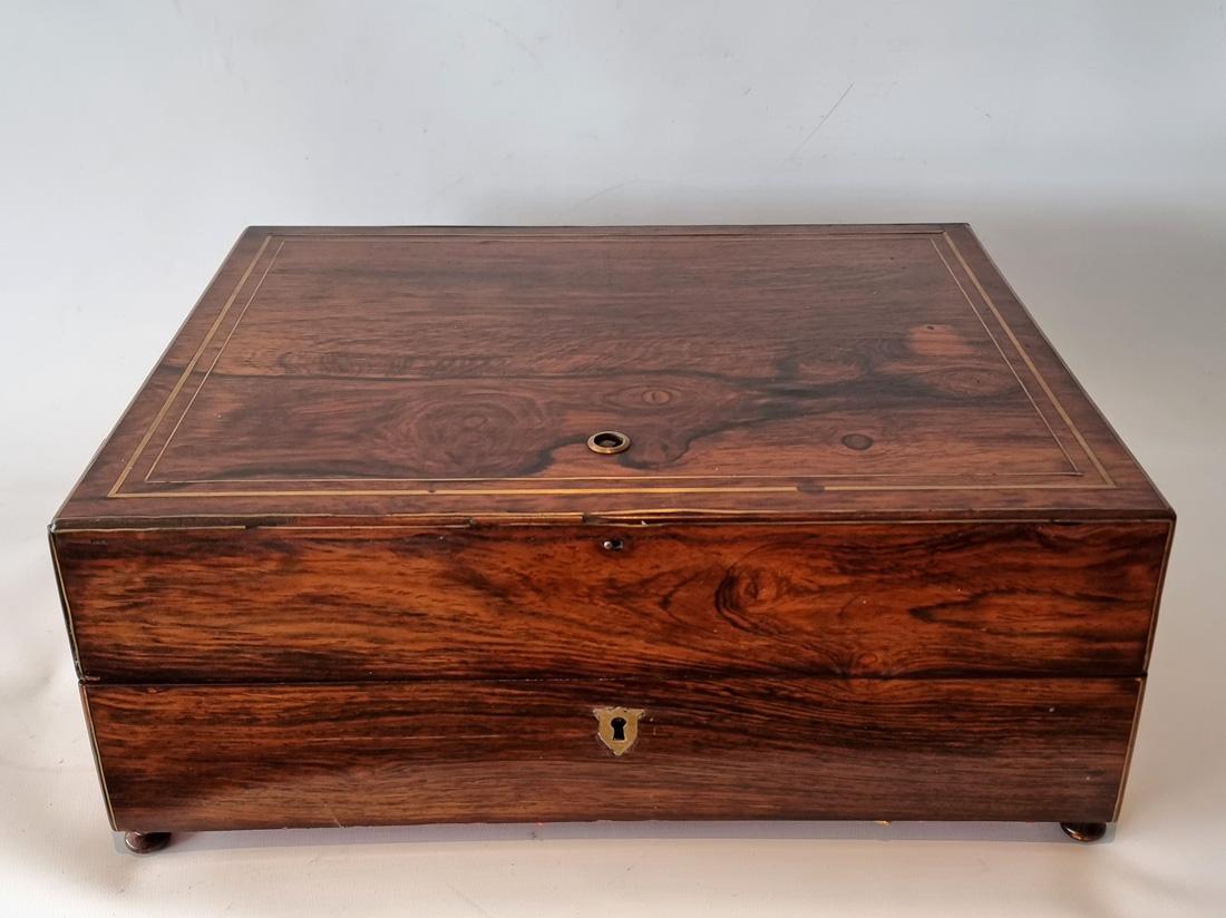 An early 19th century musical automaton necessaire box. This rare box of good size, when opened, the music plays automatically, or by activating a switch. In the box is a removable tray featuring a sewing set. On the underside of the lid, is a