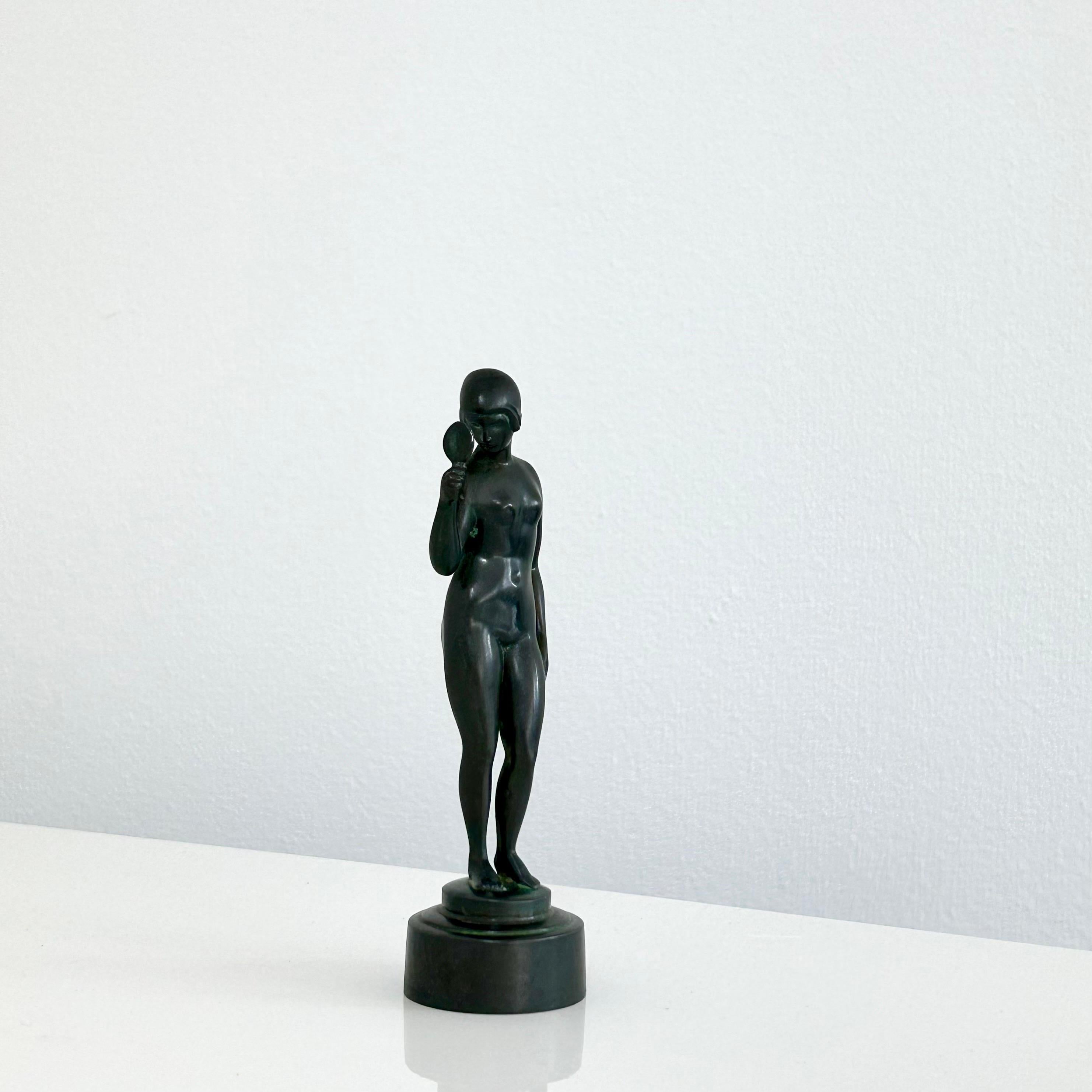 A 1920s figurine by Just Andersen. It is one of the early-works by Just Andersen and quit rare to find her with the mirror intact. A perfect detail for the modern space. 

* A small metal bust of a woman with a mirror.
* Designer: Just Andersen
*