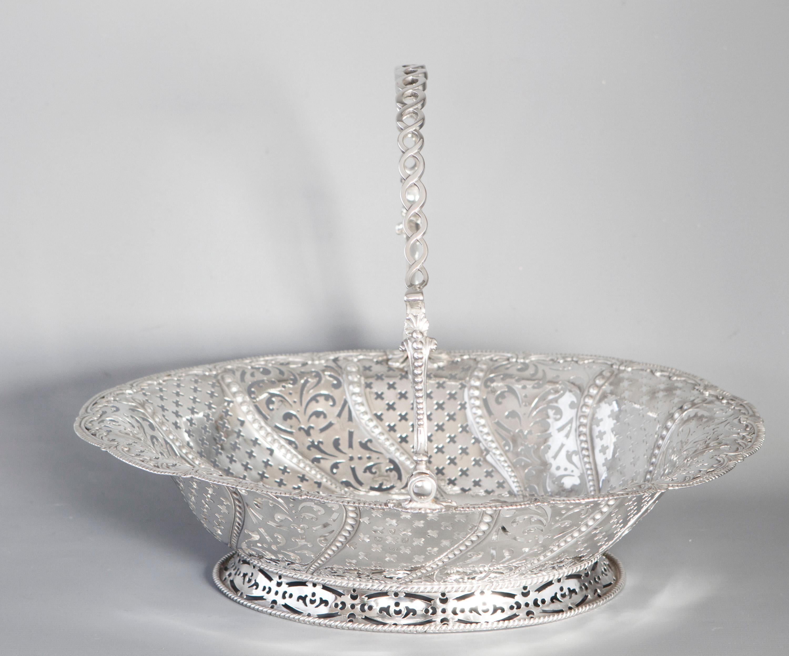 A very fine George III Silver Basket by William Plummer, London 1761. Of oval form, with pierced sides alternating in sections between cross and foliate patterns separated by tapering embossed beaded design. Shell and gadrooned boarder. Rope twist