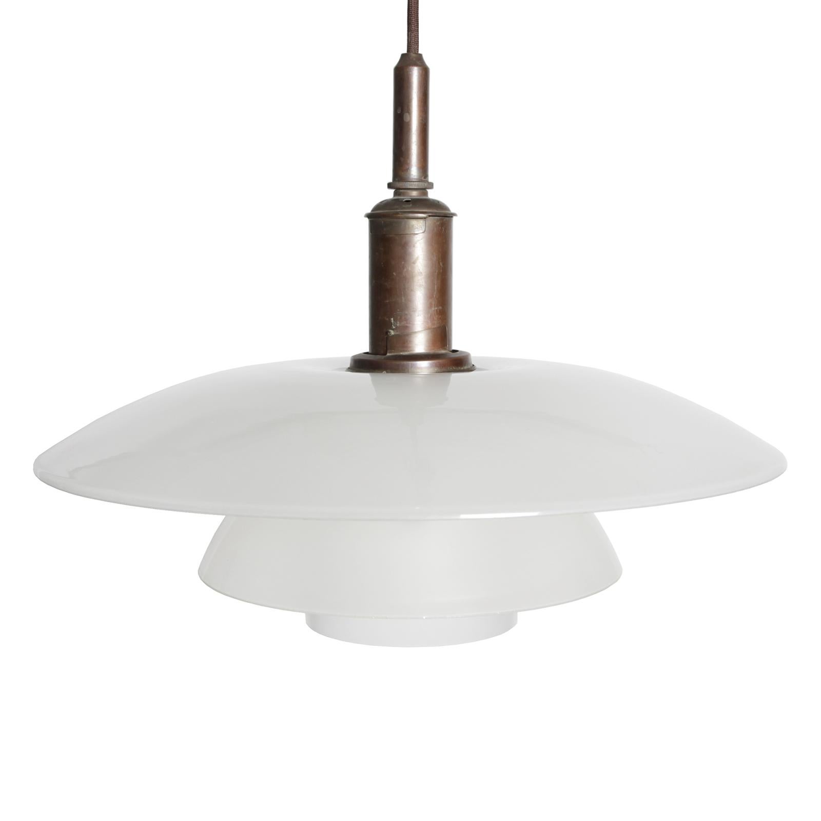 An early PH three-shade pendant with original shades in matte frosted glass with brass fixtures.
Designed by Poul Henningsen in 1927. Made by Louis Poulsen, Denmark.
