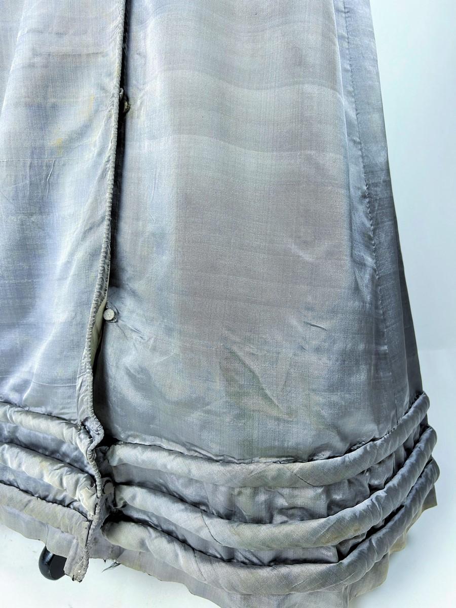 Circa 1820-1825
Francia
Un abito redingote o Douillette in lévantine come mostrato nelle litografie dei Costumi Parigini dei periodi del Primo Impero e della Restaurazione francese. Abito cappotto doppiopetto in twill di seta grigio topo, chiamato