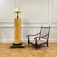 An early nineteenth century brass column lamp