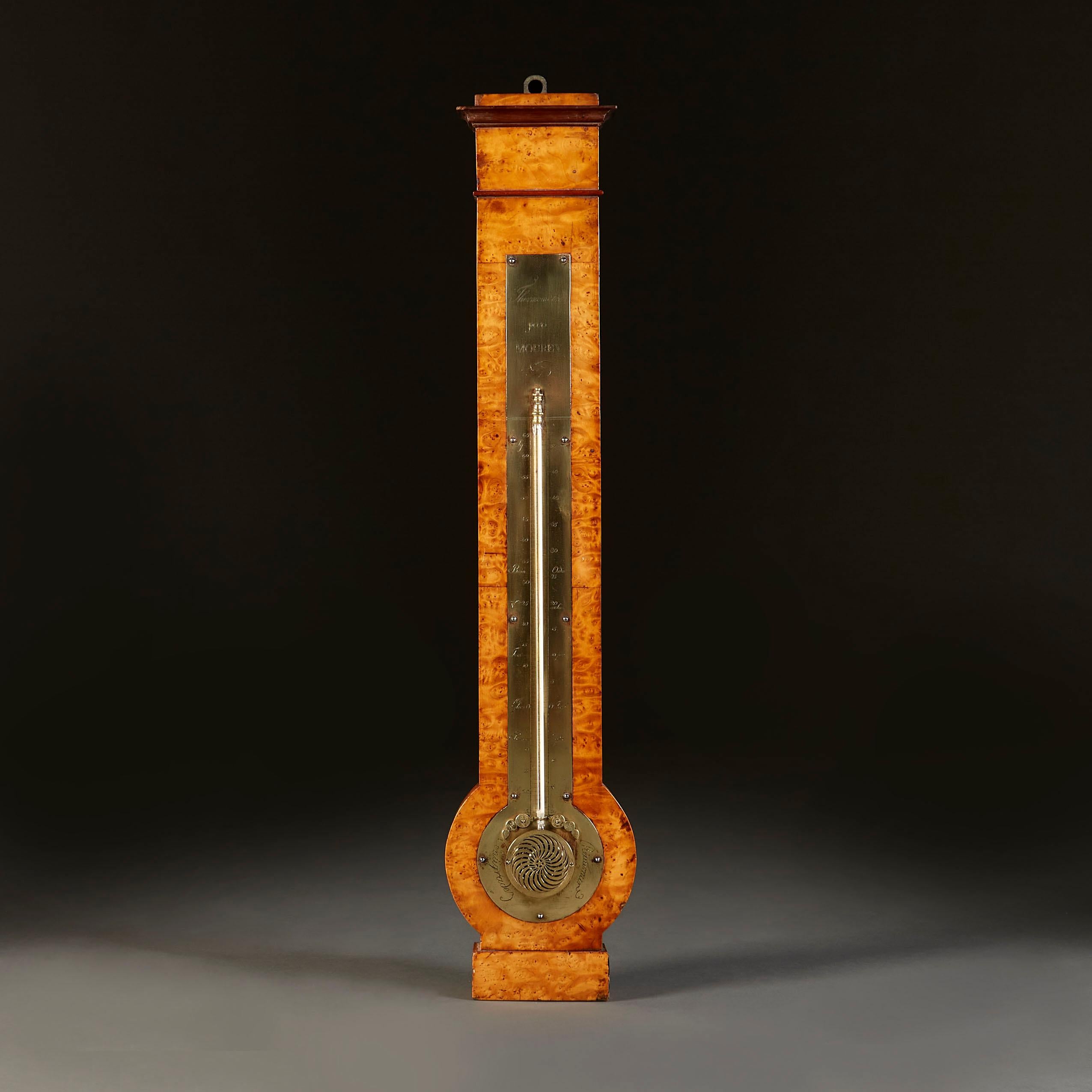 An early 19th century French Thuya wood thermometer, with brass plate inscribed with 'Thermometre par Mouyer Nancy’. The thermometer tube is sat behind a brass plate to the base, with swirling pattern and central star motif.