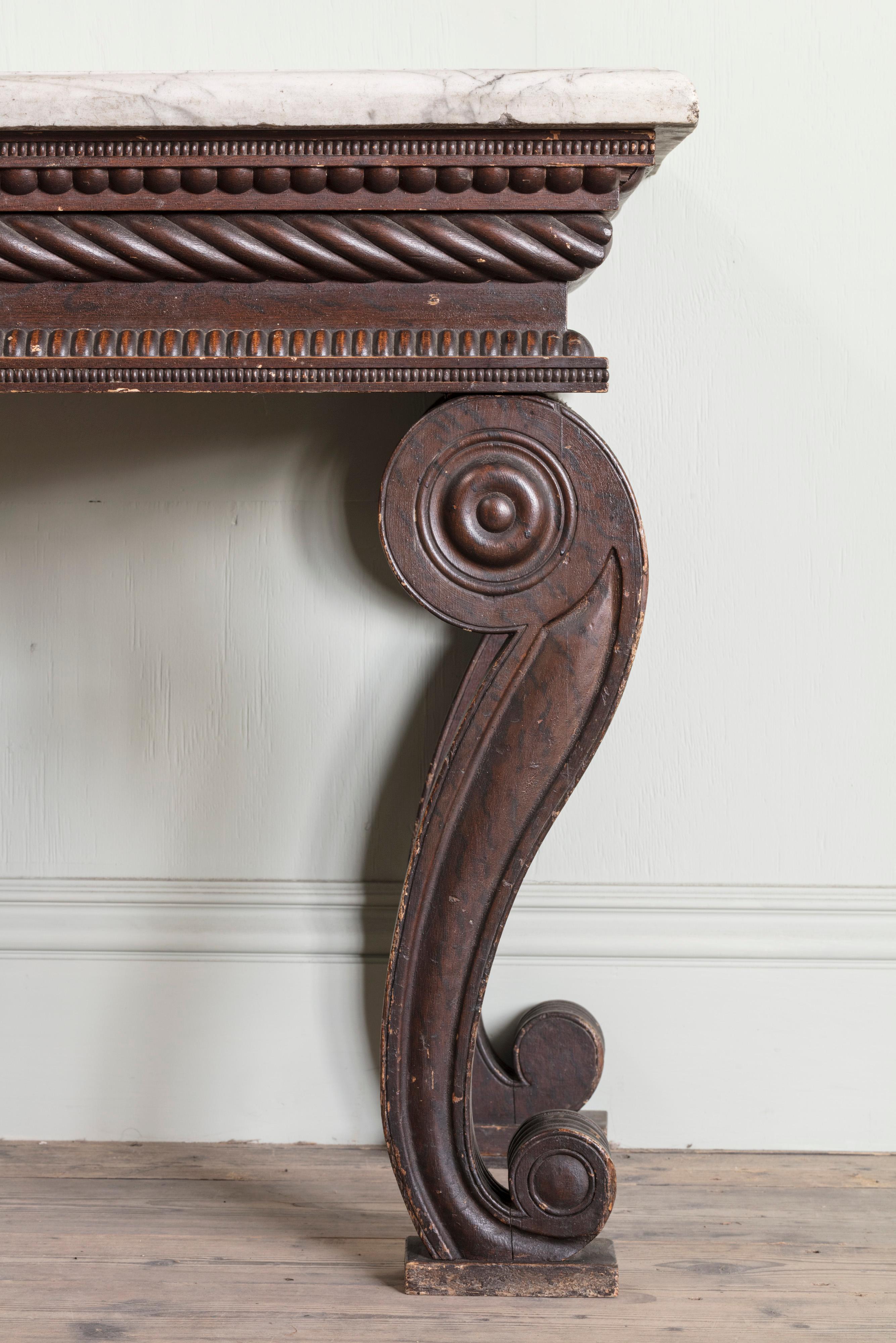 An Early Nineteenth Century Painted and Grained Side Table

Of unusual form with Carrara marble top above a gadrooned frieze on volute outscrolled legs.

Height: 82 cm, 32 1/4″
Depth: 67.5 cm, 26 5/8″
Width: 143 cm, 56 1/4″

